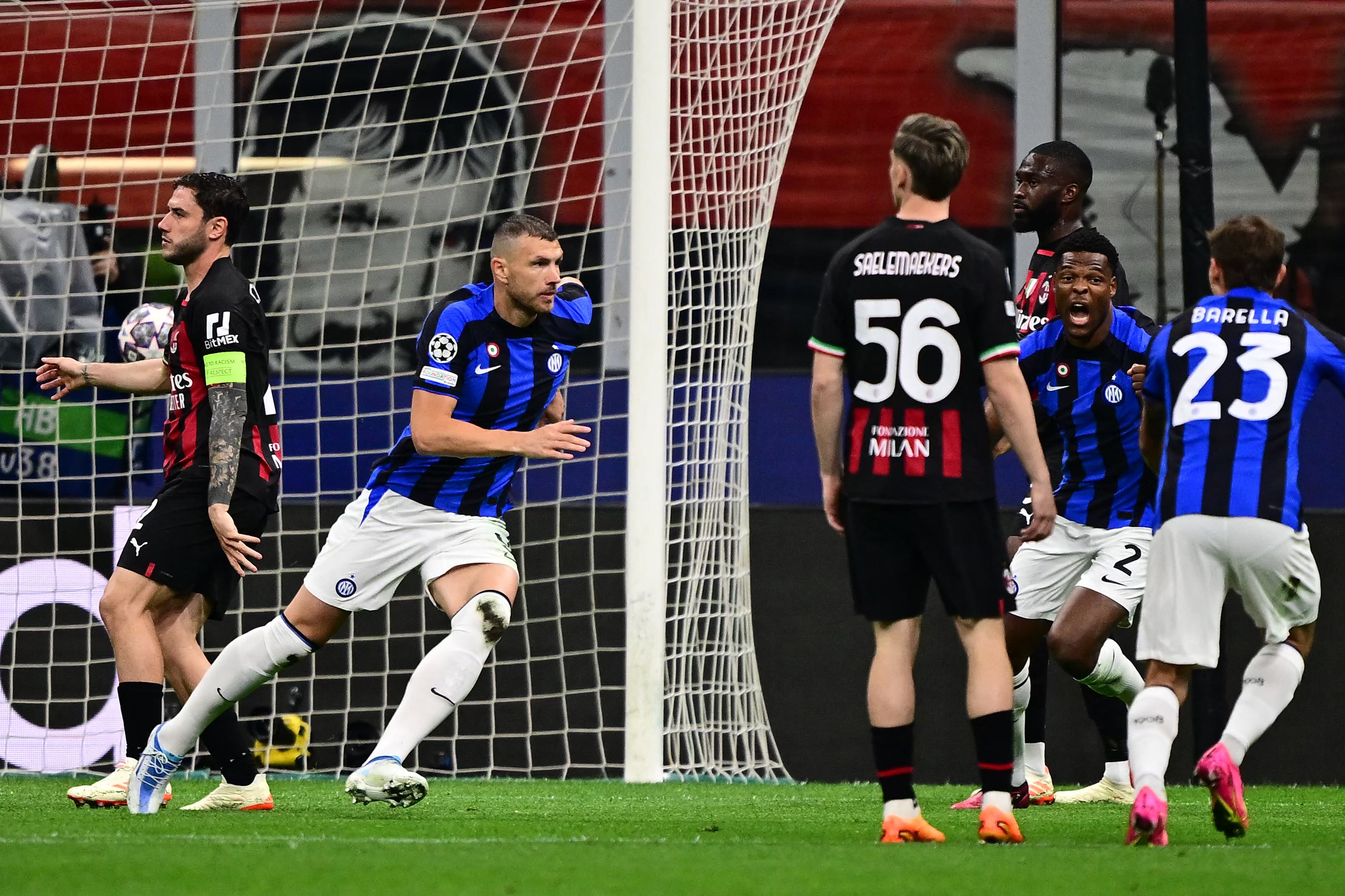 Inter Milan's Bosnian forward Edin Dzeko (2ndL) celebrates after opening the scoring during the UEFA Champions League semi-final first leg football match between AC Milan and Inter Milan, on May 10, 2023 at the San Siro stadium in Milan. (Photo by Marco BERTORELLO / AFP)
