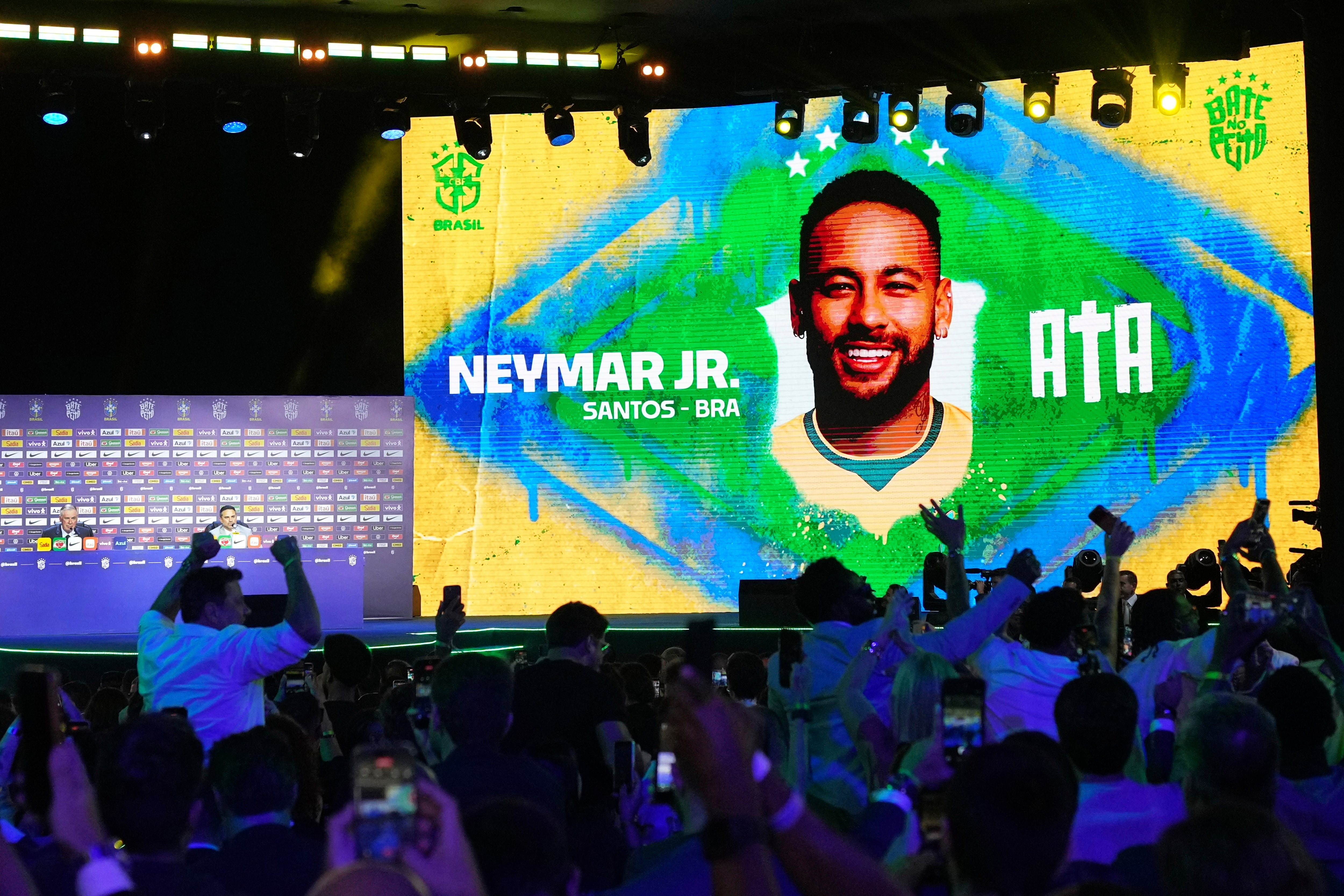 A screen displays an image of Neymar after coach Carlo Ancelotti, left, included him in Brazil's squad for the 2026 FIFA World Cup in Rio de Janeiro, Monday, May 18, 2026. (AP Photo/Silvia Izquierdo)