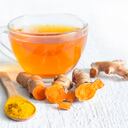 Raw roots of tumeric and tea on white planks detox concept closeup