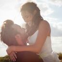 Newlywed groom holding bride outdoors