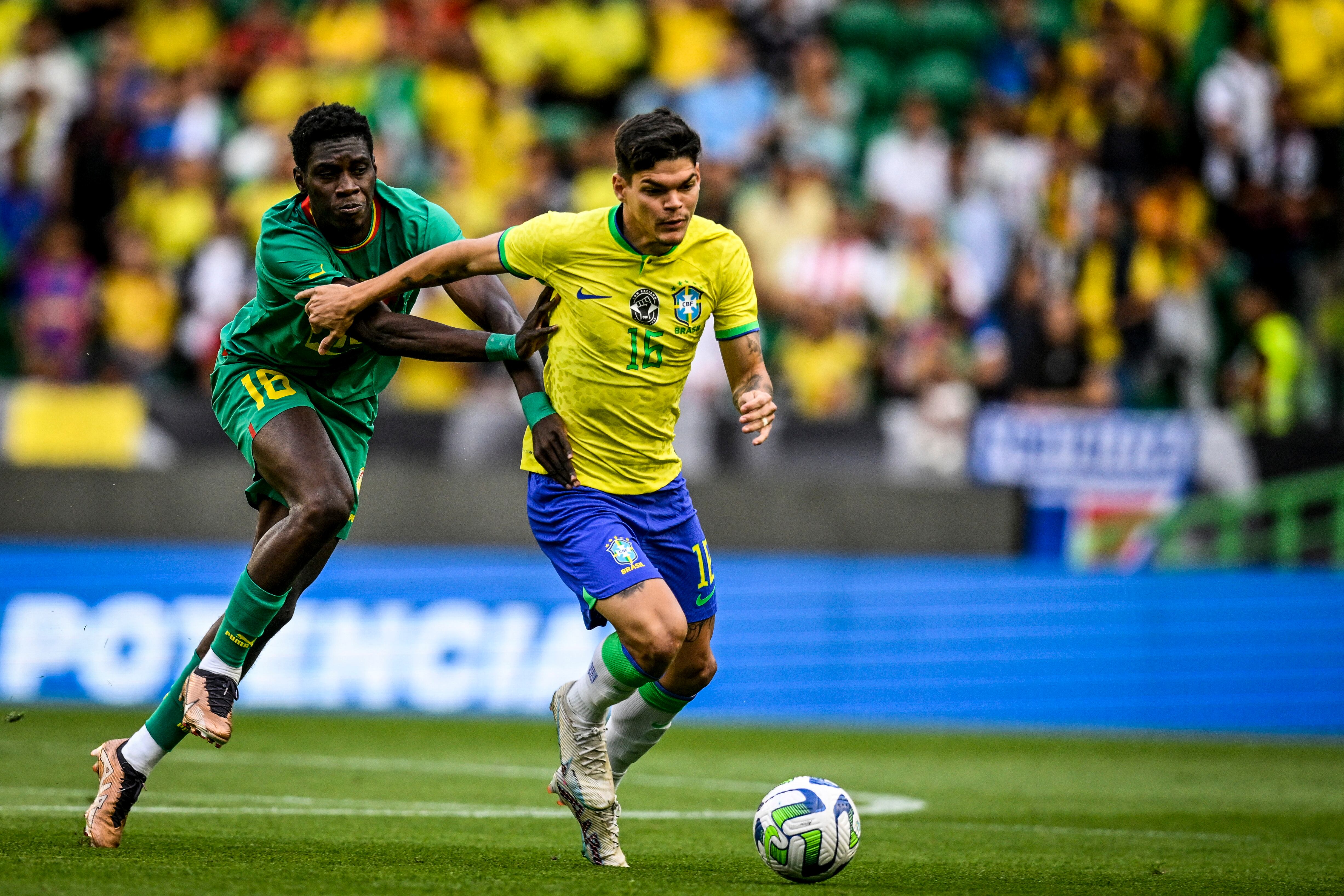 Ayrton Lucas peleando un balón con rival de Senegal.