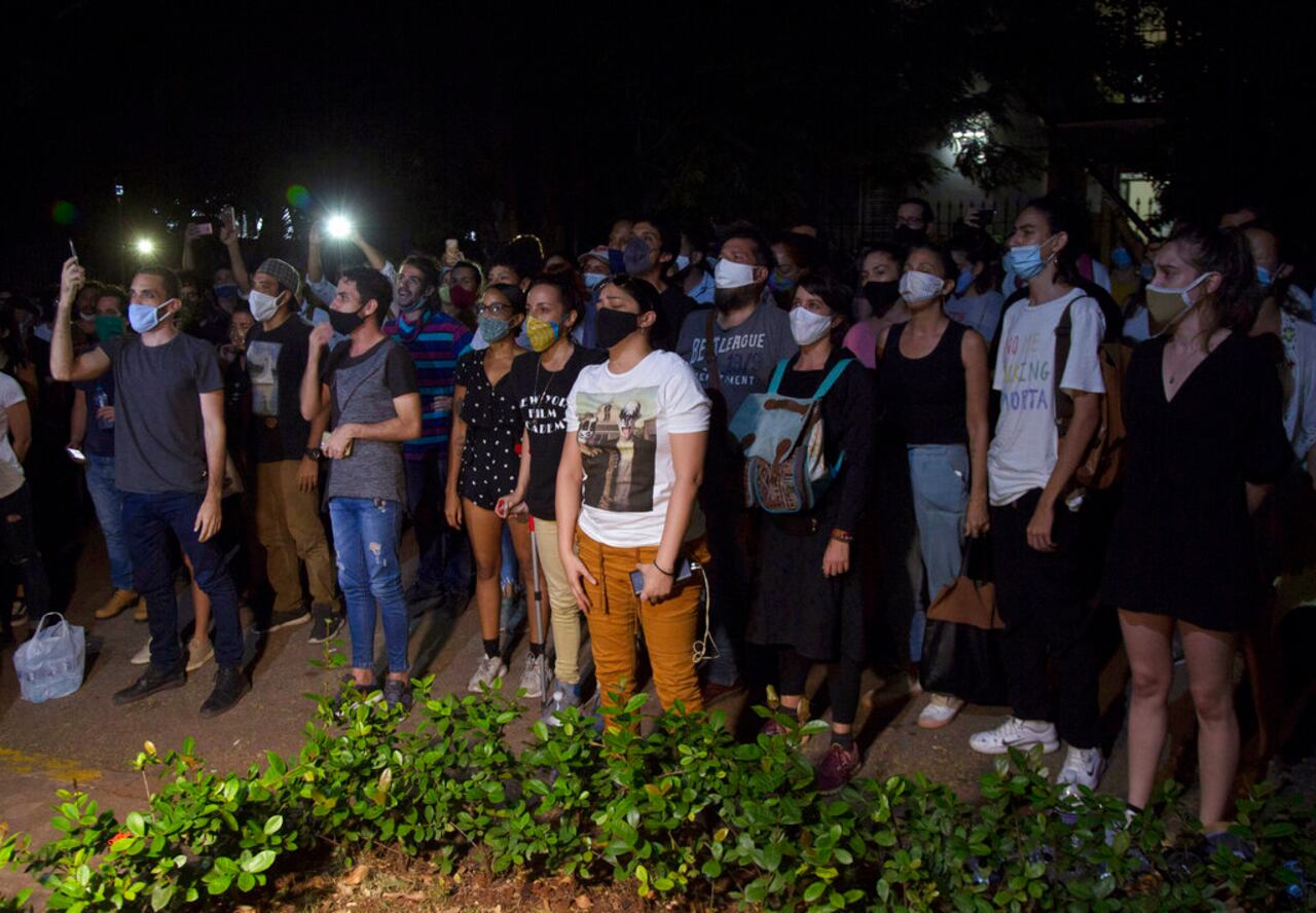 Young artists protest in front of the doors of the Ministry of Culture, in Havana, Cuba, Friday, Nov. 27, 2020. Dozens of Cuban artists demonstrated against the police evicting a group who participated in a hunger strike. (AP Photo/Ismael Francisco)