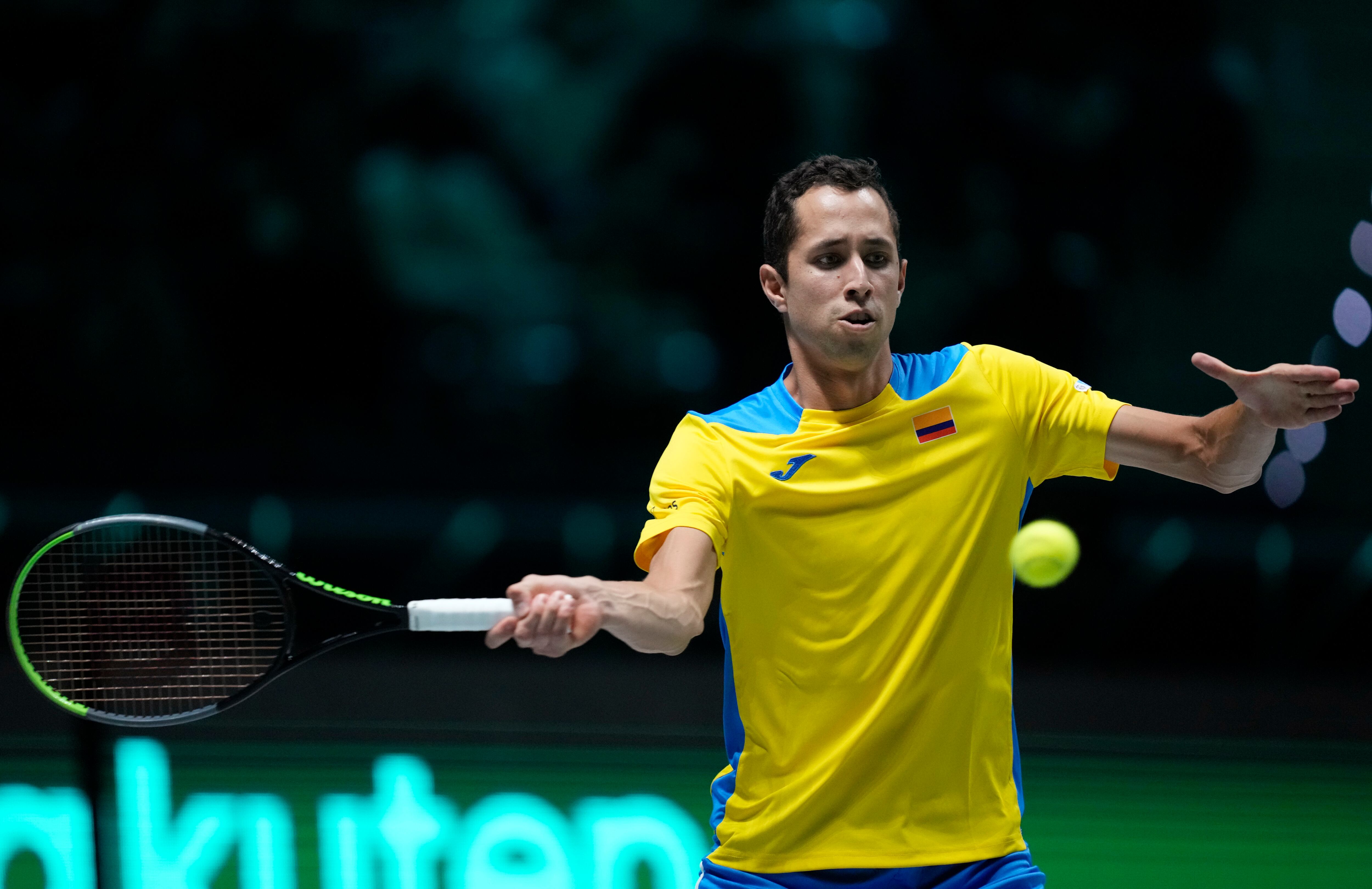 Colombia's Daniel Elahi Galan returns the ball to Italy's Jannik Sinner during their Davis Cup men's single Finals tennis match at the Pala Alpitour in Turin, Italy, Saturday, Nov. 27, 2021. (AP Photo/Antonio Calanni)