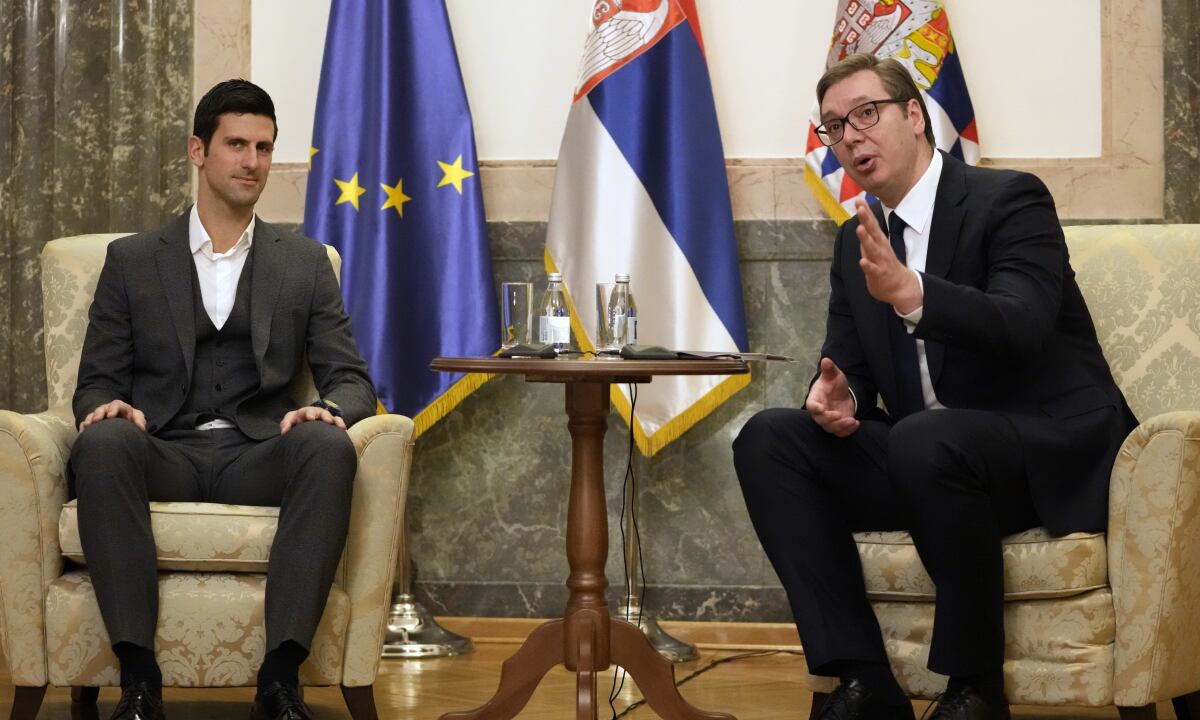 Serbian tennis player Novak Djokovic, left, speaks with Serbia's President Aleksandar Vucic in Belgrade, Serbia, Thursday, Feb. 3, 2022. Serbia's state prosecutors have rejected suggestions that Novak Djokovic used a fake positive test for COVID-19 to try to enter Australia and compete in the Australian Open. (AP/Darko Vojinovic)