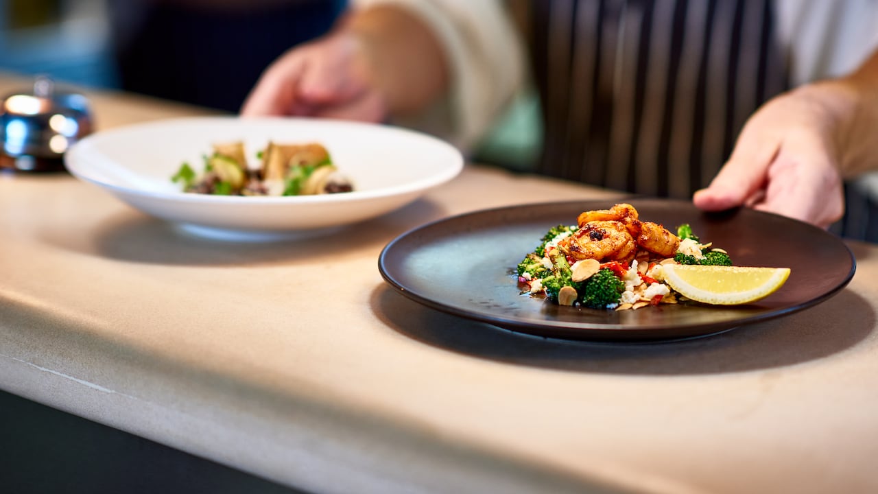 Professional chef working in commercial kitchen, preparing food, serving meal, service