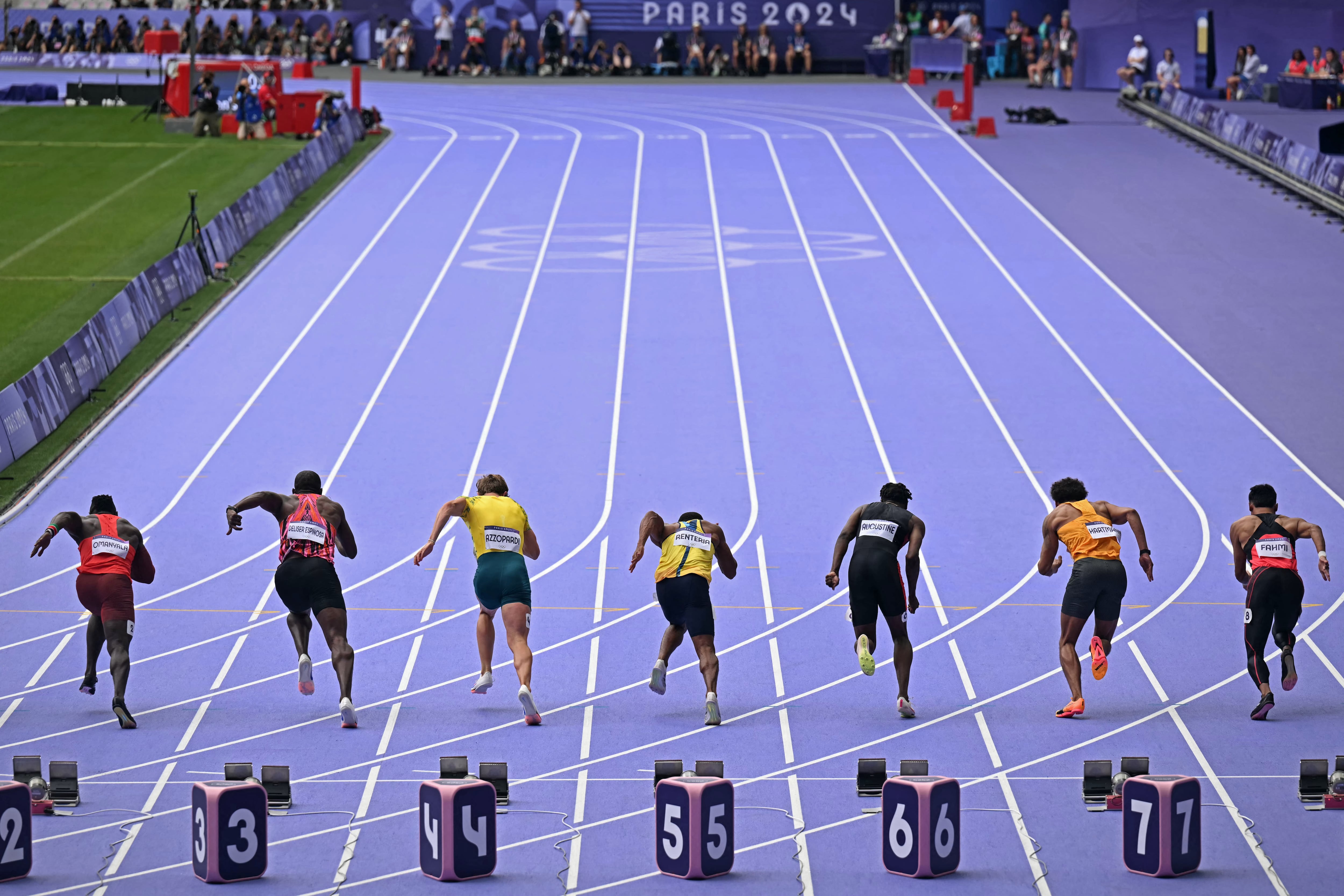 (From L) Kenya's Ferdinand Omanyala, Panama's Arturo Harmodio Deliser Espinosa, Australia's Joshua Azzopardi, Colombia's Jhonny Alexander Renteria Jimenez, Trinidad and Tobago's Devin Augustine, Germany's Joshua Hartmann and Malaysia's Muhd Azeem Fahmi take the start in the men's 100m heat of the athletics event at the Paris 2024 Olympic Games at Stade de France in Saint-Denis, north of Paris, on August 3, 2024. (Photo by MARTIN BERNETTI / AFP)
