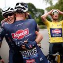 Stage winner Belgium's Tim Merlier, left, is hugged by teammate Belgium's Jonas Rickaert as Netherland's Mathieu Van Der Poel, wearing the overall leader's yellow jersey, joins in celebrations after the third stage of the Tour de France cycling race over 182.9 kilometers (113.65 miles) with start in Lorient and finish in Pontivy, France, Monday, June 28, 2021. (Stephane Mahe/Pool Photo via AP)