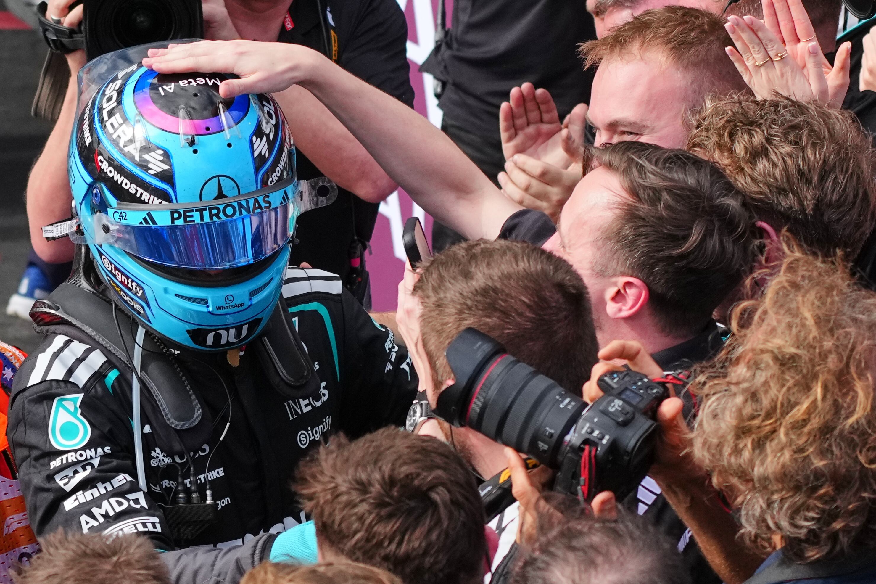 Mercedes driver George Russell of Britain is congratulated by his team after winning the Australian Formula One Grand Prix at Albert Park, in Melbourne, Australia, Sunday, March 8, 2026. (AP Photo/Scott Barbour)