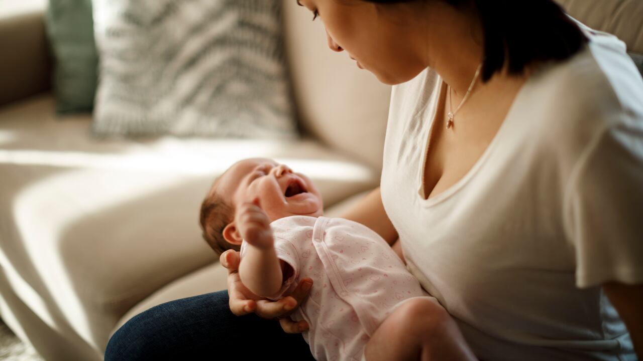 Newborn baby crying in mother hands