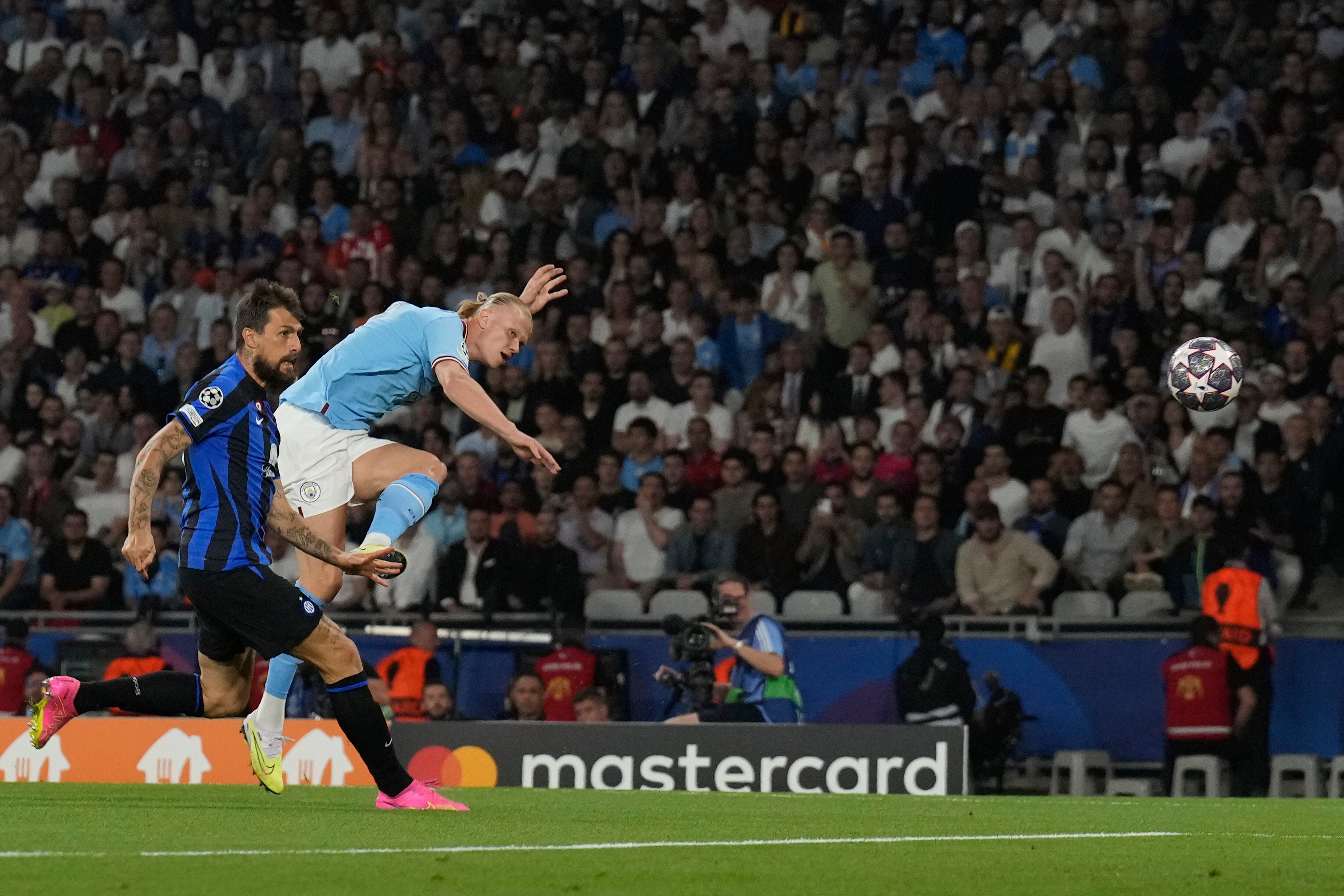 Erling Haaland, de Manchester City, a la derecha, intenta un tiro al arco frente a Francesco Acerbi, del Inter de Milán, durante el partido final de la Liga de Campeones entre el Manchester City y el Inter de Milán en el Estadio Olímpico Ataturk en Estambul, Turquía, el sábado 10 de junio de 2023. ( Foto AP/Antonio Calanni)