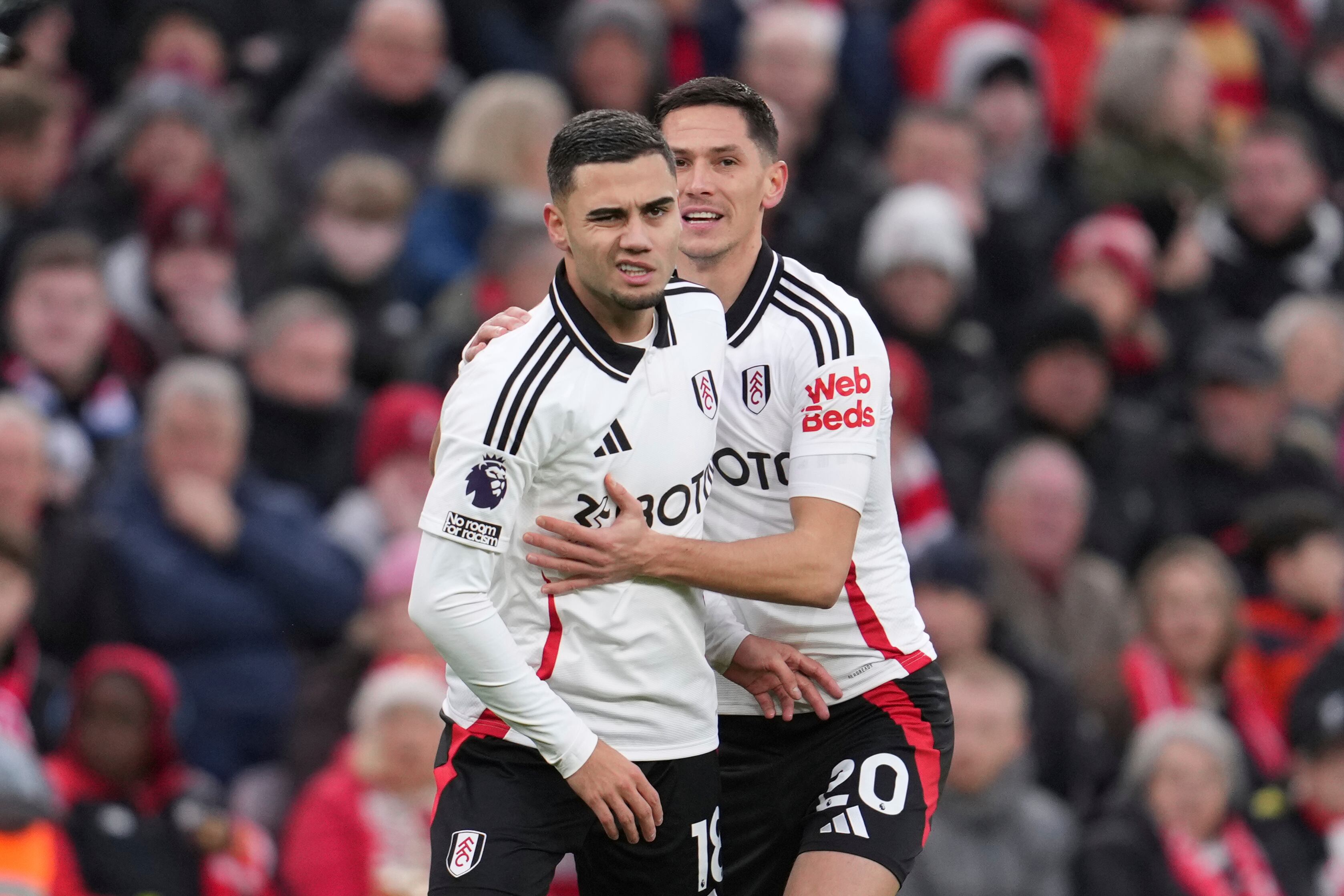 Fulham's Andreas Pereira, left, celebrates with Fulham's Sasa Lukic after scoring his side's opening goal during the English Premier League soccer match between Liverpool and Fulham, at Anfield stadium in Liverpool, England, Saturday, Dec. 14, 2024. (AP Photo/Jon Super)