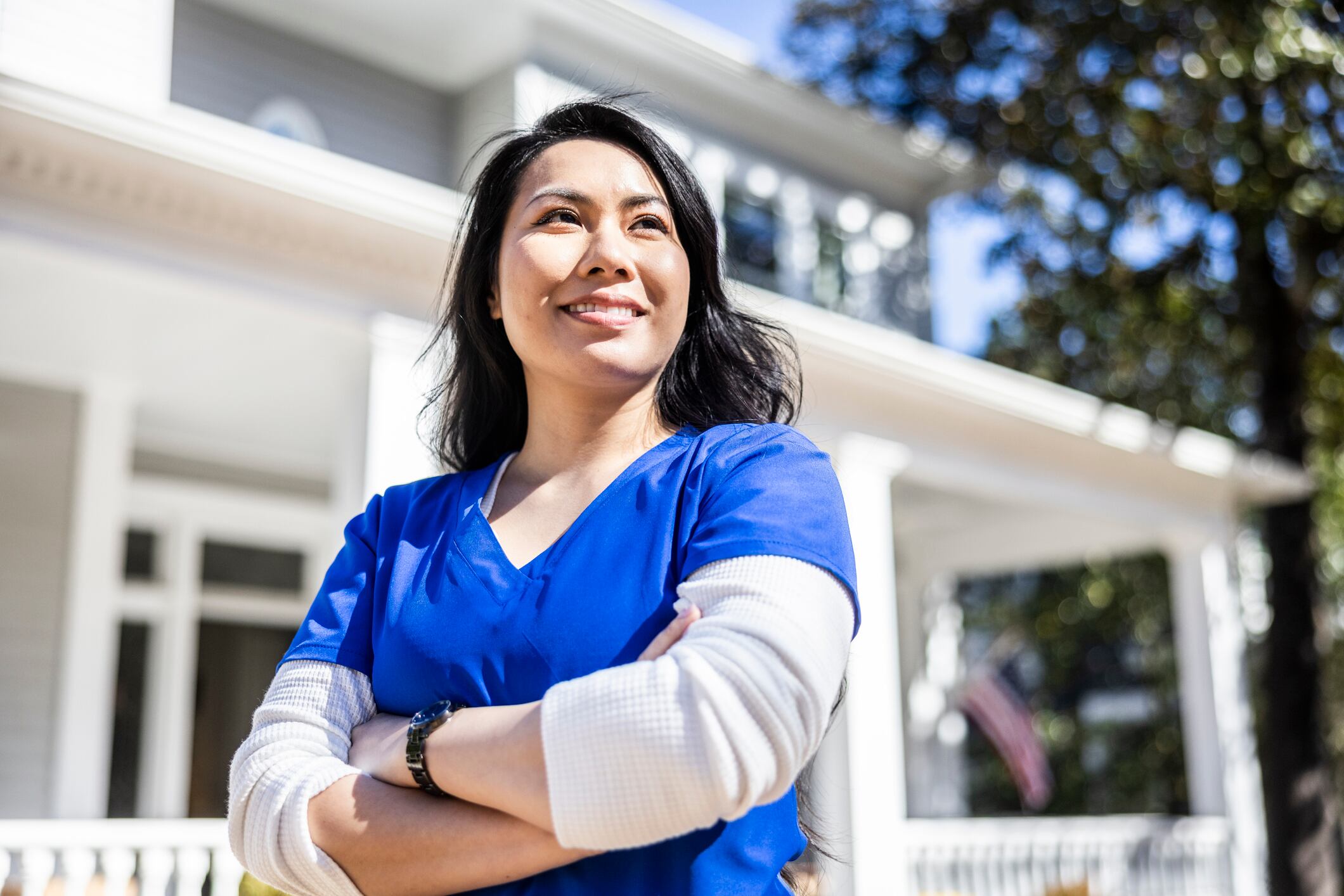 Portrait of nurse in front of suburban home