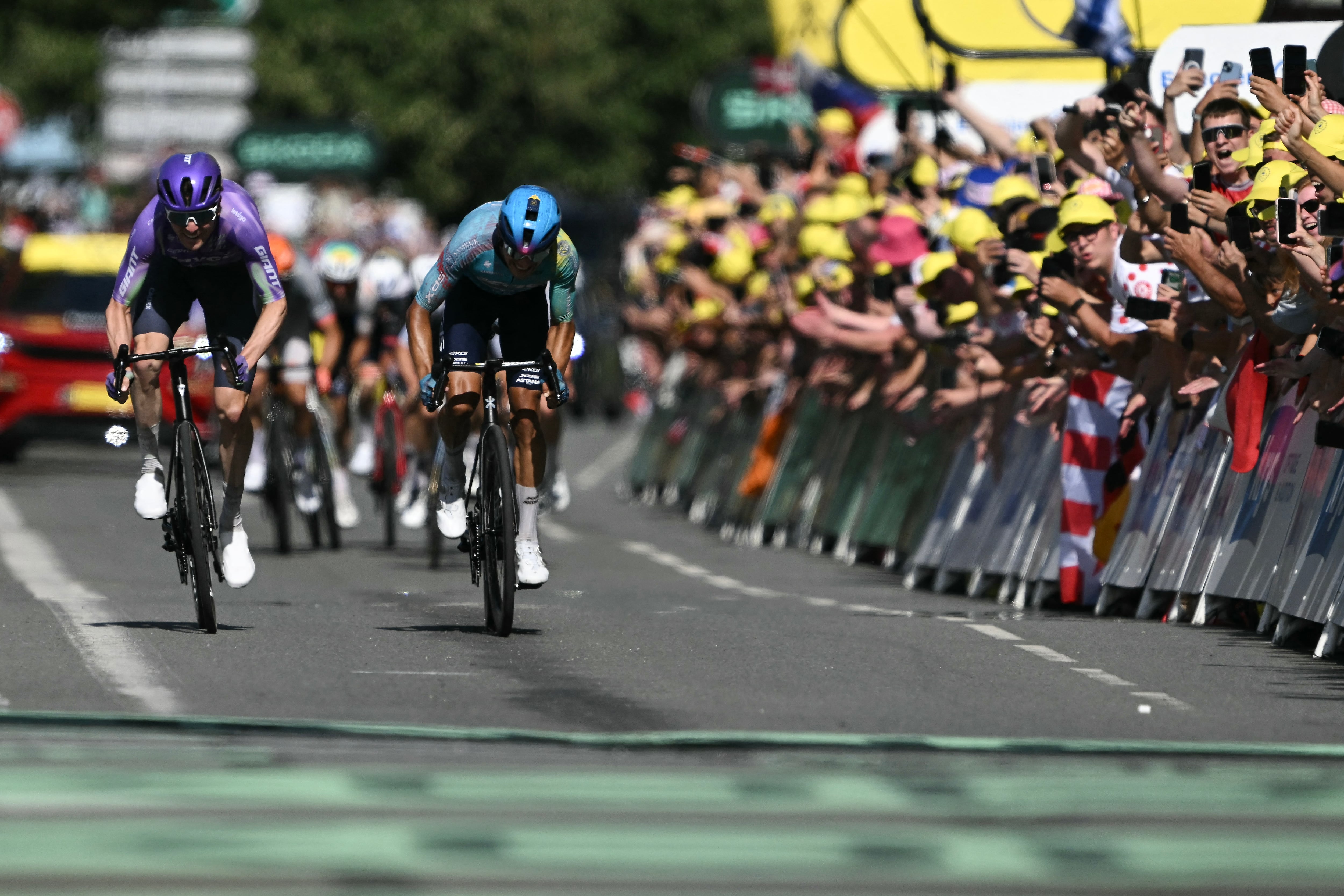 Team Jayco AlUla's Swiss rider Mauro Schmid (L) cycles to the finish line ahead of XDS Astana Team's Colombian rider Harold Tejada (R) to win the 13th stage of the 113th edition of the Tour de France cycling race, 205,8 km between Dole and Belfort in eastern France, on July 17, 2026. (Photo by Jeff PACHOUD / AFP)