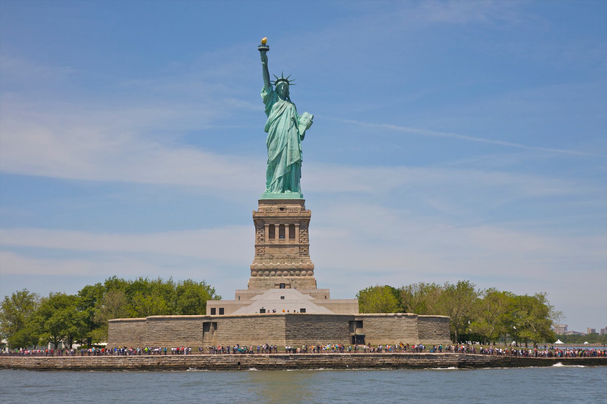 Crowd lined up on Liberty Island below Statue of Liberty, New York, NY, USA.