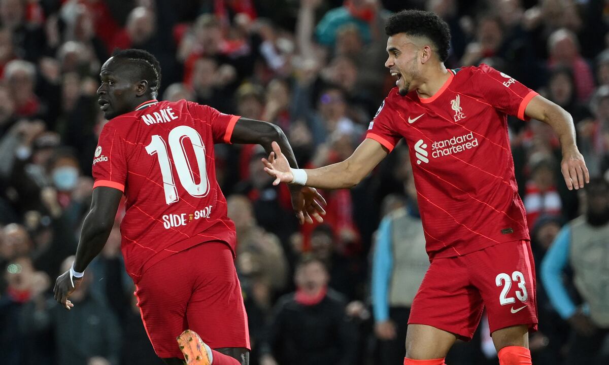 Liverpool's Senegalese striker Sadio Mane (L) celebrates with Liverpool's Colombian midfielder Luis Diaz after scoring his team second goal during the UEFA Champions League semi-final first leg football match between Liverpool and Villarreal, at the Anfield Stadium, in Liverpool, on April 27, 2022.
AFP/LLUIS GENE