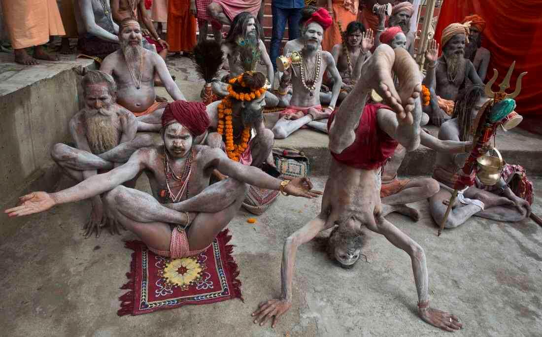 Sadhus indios o hombres sagrados hindúes realizan Yoga para celebrar el Día Internacional del Yoga en el templo de Kamakhya en Gauhati, India, el miércoles 21 de junio de 2017. Los practicantes de yoga tomaron un descanso para doblarse, retorcerse y posar el miércoles por la mañana para el evento anual Celebrando la práctica, especialmente en el país donde comenzó. (AP Photo / Anupam Nath)  
