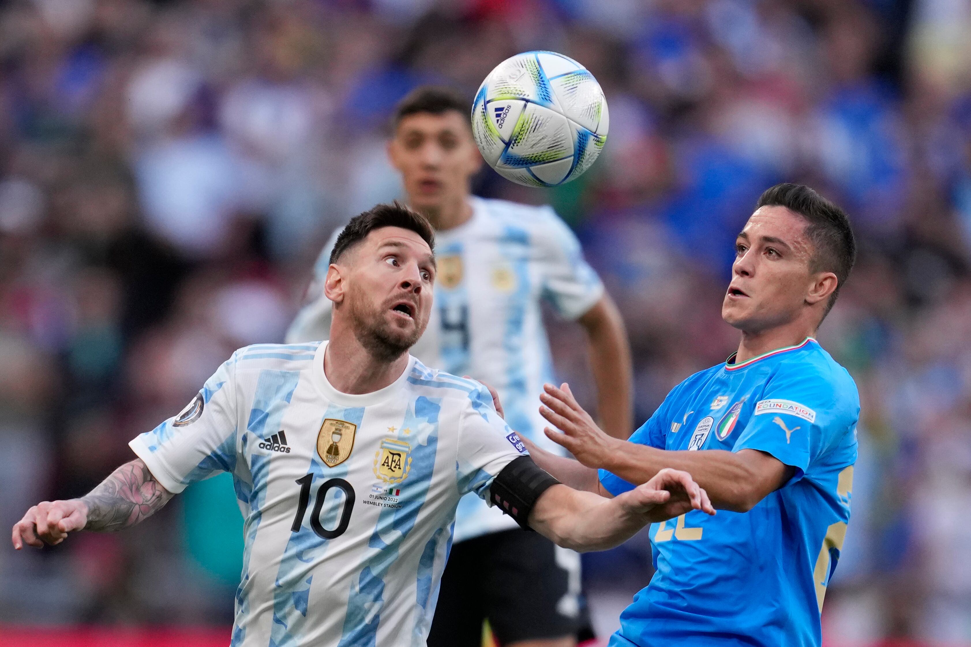 Argentina's Lionel Messi, left, challenges for the ball with Italy's Giacomo Raspadori during the Finalissima soccer match between Italy and Argentina at Wembley Stadium in London , Wednesday, June 1, 2022. (AP Photo/Matt Dunham)