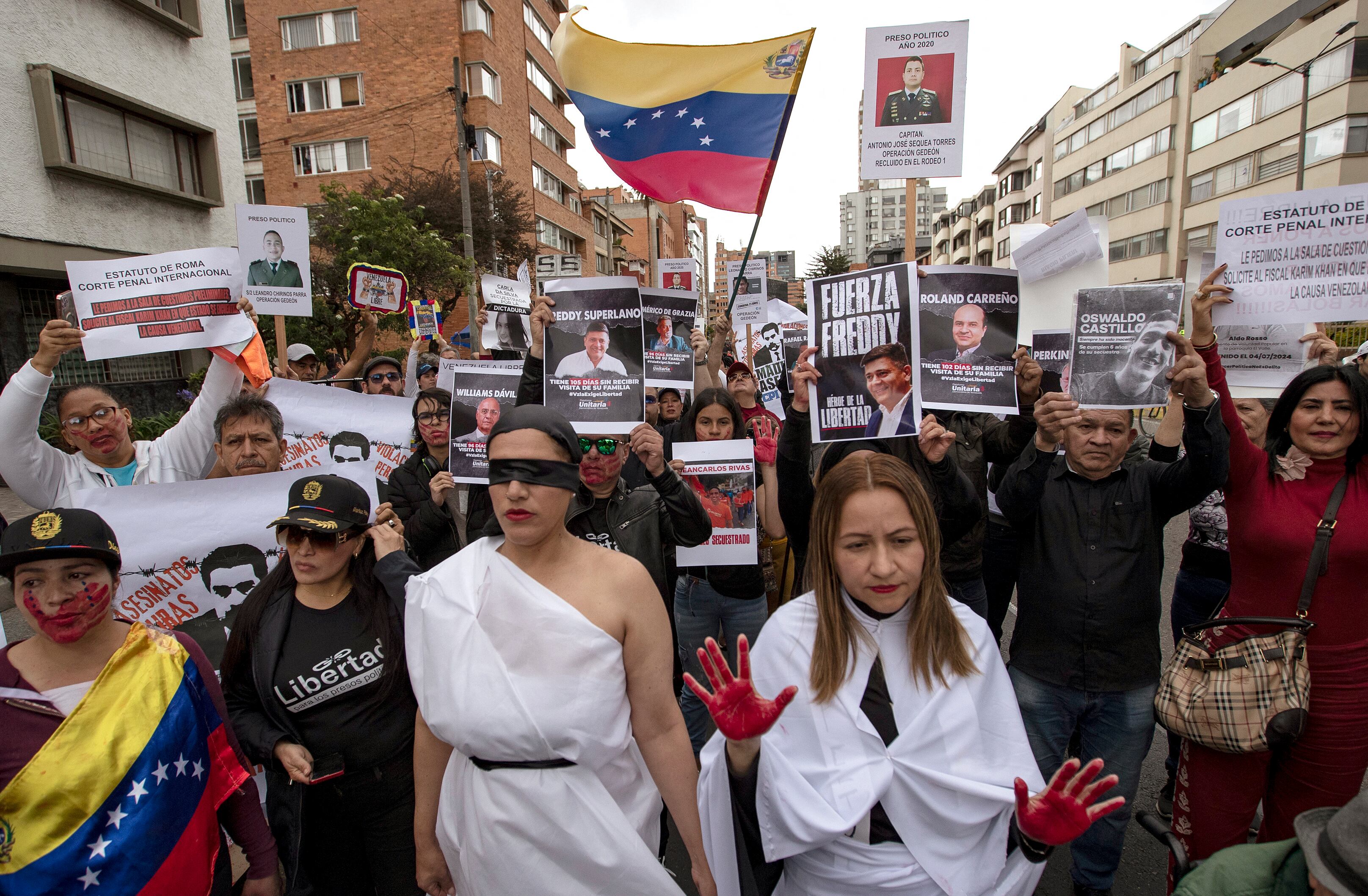 Manifestantes sostienen carteles contra el gobierno del presidente venezolano Nicolás Maduro durante una manifestación en Bogotá el 1 de diciembre de 2024