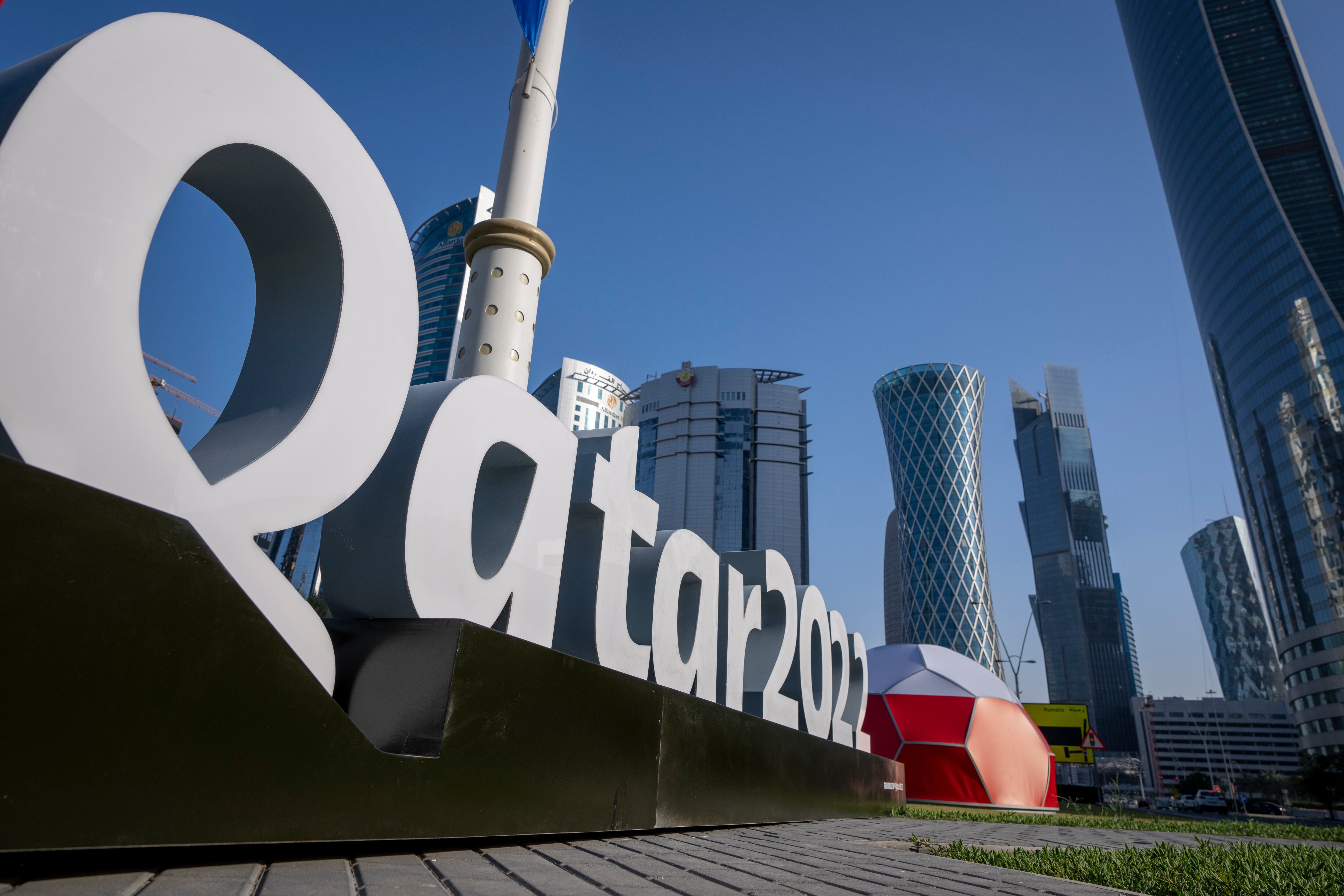 Branding is displayed near the Doha Exhibition and Convention Center where soccer World Cup draw will be held, in Doha, Qatar, Thursday, March 31, 2022. The final draw will be held on April 1. (AP Photo/Darko Bandic)