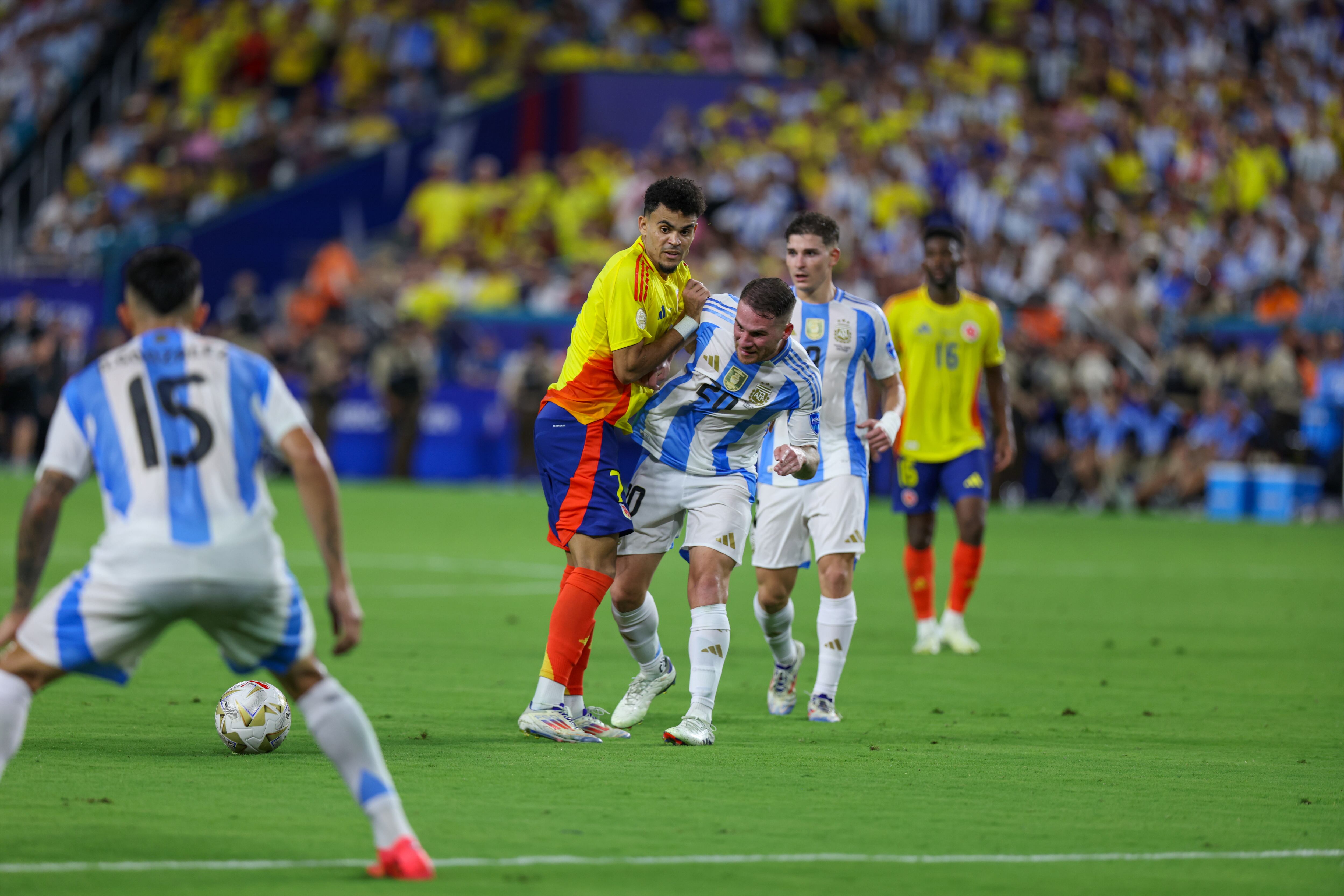 MIAMI GARDENS, FLORIDA - JULY 14: Alexis Mac Allister #20 of Argentina tackles the ball away from Luis Diaz #7 of Colombia during a game between Colombia and Argentina at Hard Rock Stadium on July 14, 2024 in Miami Gardens, FL. (Photo by Roger Wimmer/ISI Photos/Getty Images)