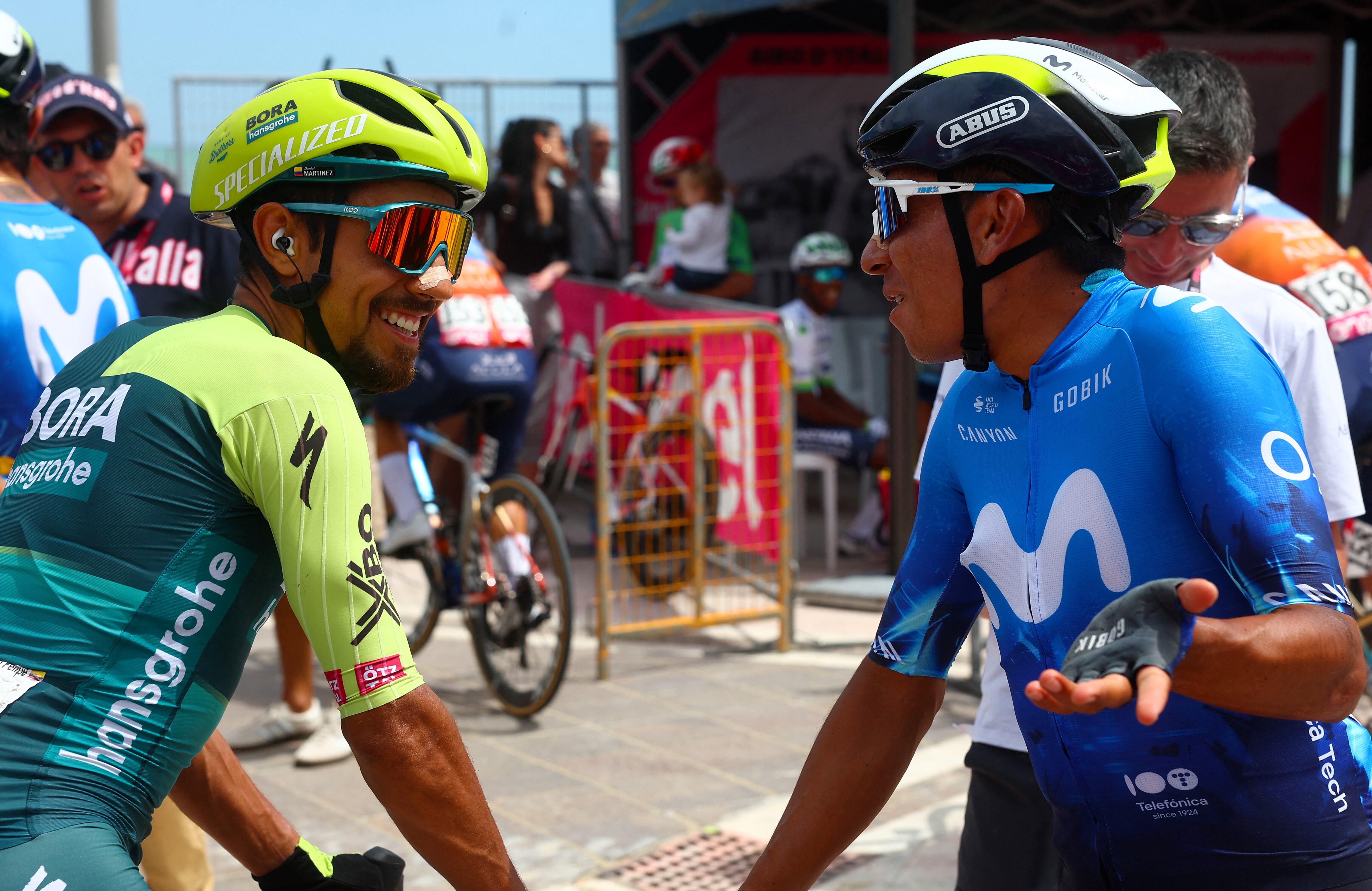 Team Bora's Colombian rider Daniel Martinez (L) chats with Team Movistar's Colombian rider Nairo Quintana during the presentation of the teams prior the 13th stage of the 107th Giro d'Italia cycling race, 179km between Riccione and Cento, on May 17, 2024. (Photo by Luca Bettini / AFP)