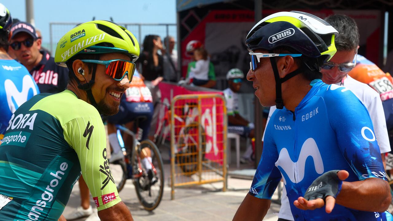Team Bora's Colombian rider Daniel Martinez (L) chats with Team Movistar's Colombian rider Nairo Quintana during the presentation of the teams prior the 13th stage of the 107th Giro d'Italia cycling race, 179km between Riccione and Cento, on May 17, 2024. (Photo by Luca Bettini / AFP)