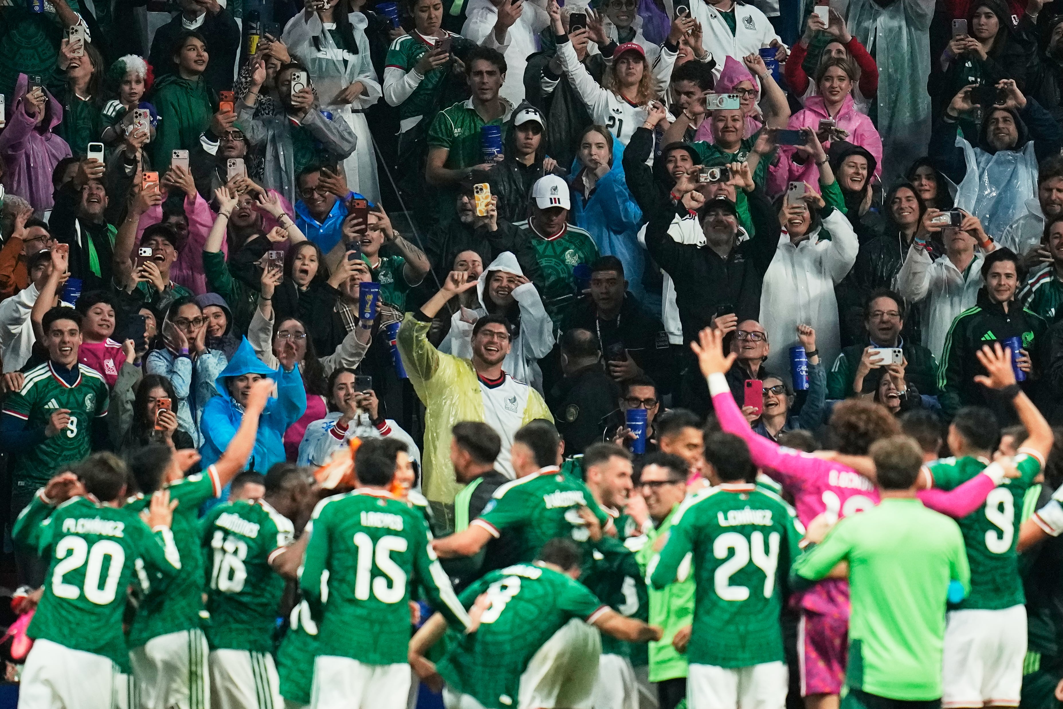 Fans celebrate with Mexico players after their team's victory over Ecuador in the World Cup round of 32 soccer match in Mexico City, Tuesday, June 30, 2026. (AP Photo/Ricardo Mazalan)