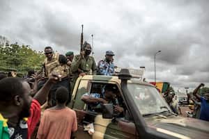FILE - People cheer in celebration as security forces drive through the streets of the capital Bamako, Mali, Wednesday, Aug. 19, 2020, a day after armed soldiers fired into the air outside President Ibrahim Boubacar Keita's home and took him into their custody. The Sahel's latest wave of coups kicked off in Mali in August 2020 when the democratically elected President Ibrahim Boubacar Keïta was overthrown by soldiers led by Col. Assimi Goita. (AP Photo, File)