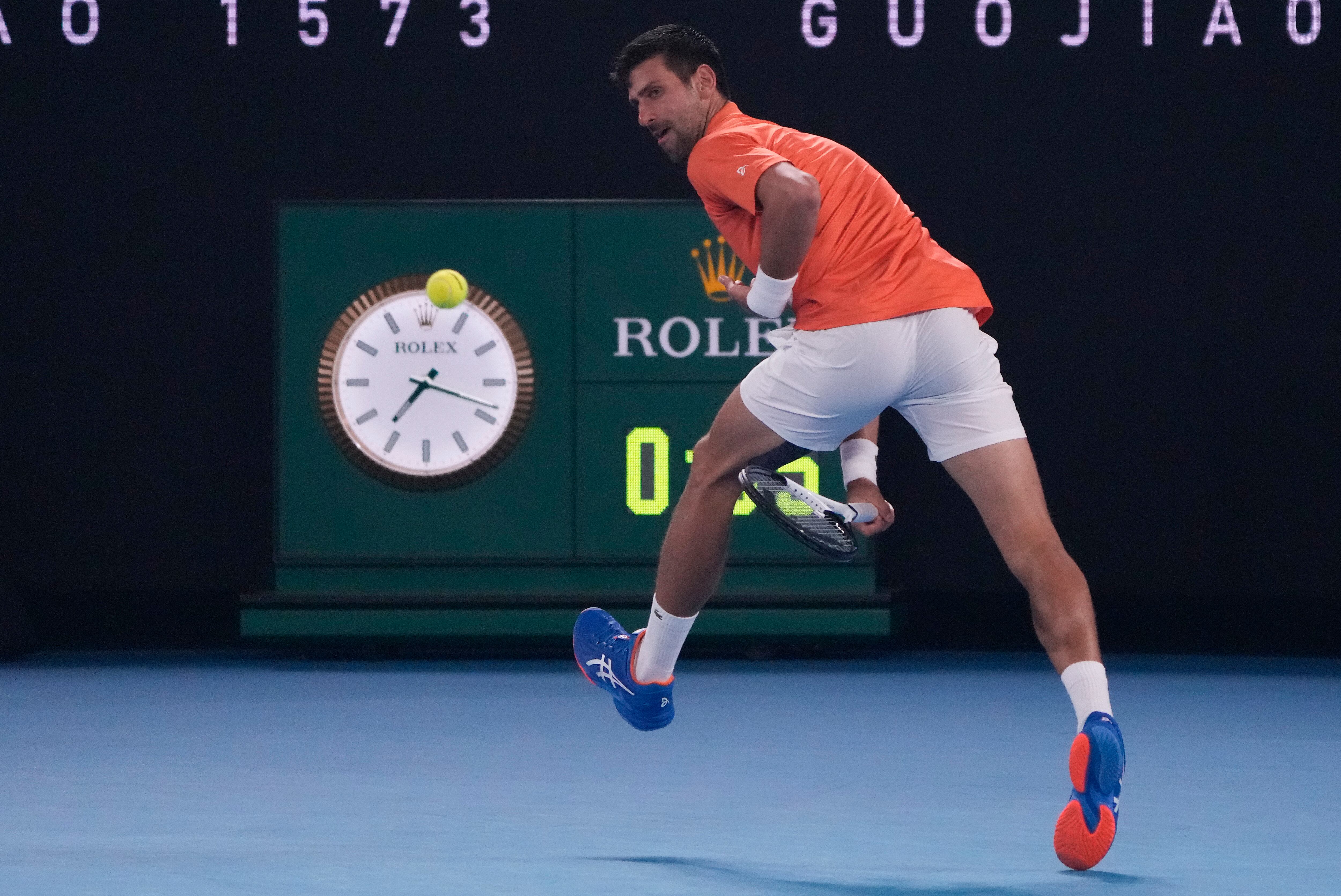 Serbia's Novak Djokovic plays a shot back between his legs during an exhibition match against Australia's Nick Kyrgios on Rod Laver Arena ahead of the Australian Open tennis championship in Melbourne, Australia, Friday, Jan. 13, 2023. (AP Photo/Mark Baker)