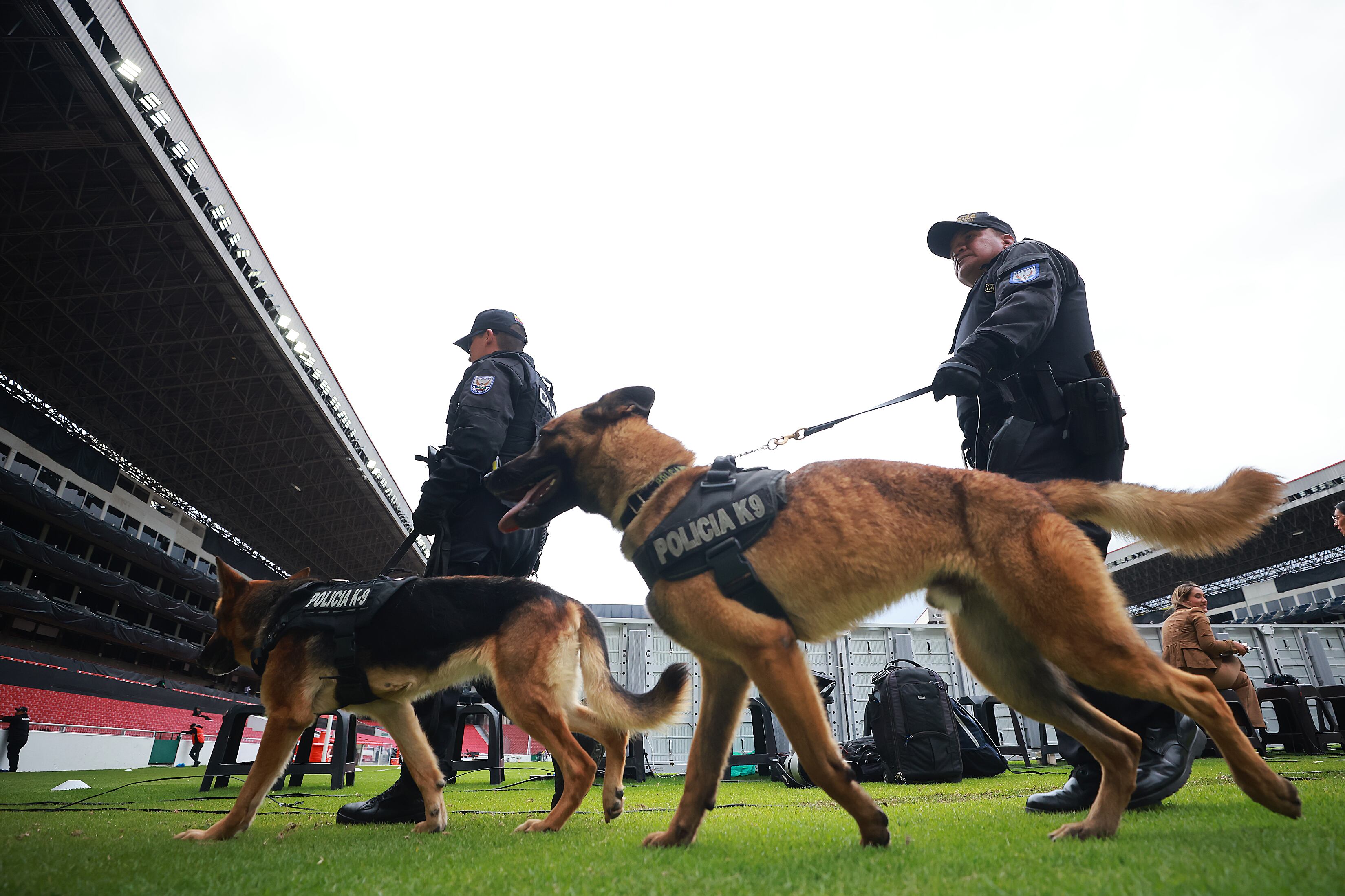 QUITO, ECUADOR - OCTOBER 28: Police officers with dogs walk inside the stadium prior the third place match of Women's Copa CONMEBOL Libertadores 2022 between Deportivo Cali and America de Cali at Rodrigo Paz Delgado Stadium on October 28, 2022 in Quito, Ecuador. (Photo by Hector Vivas/Getty Images)