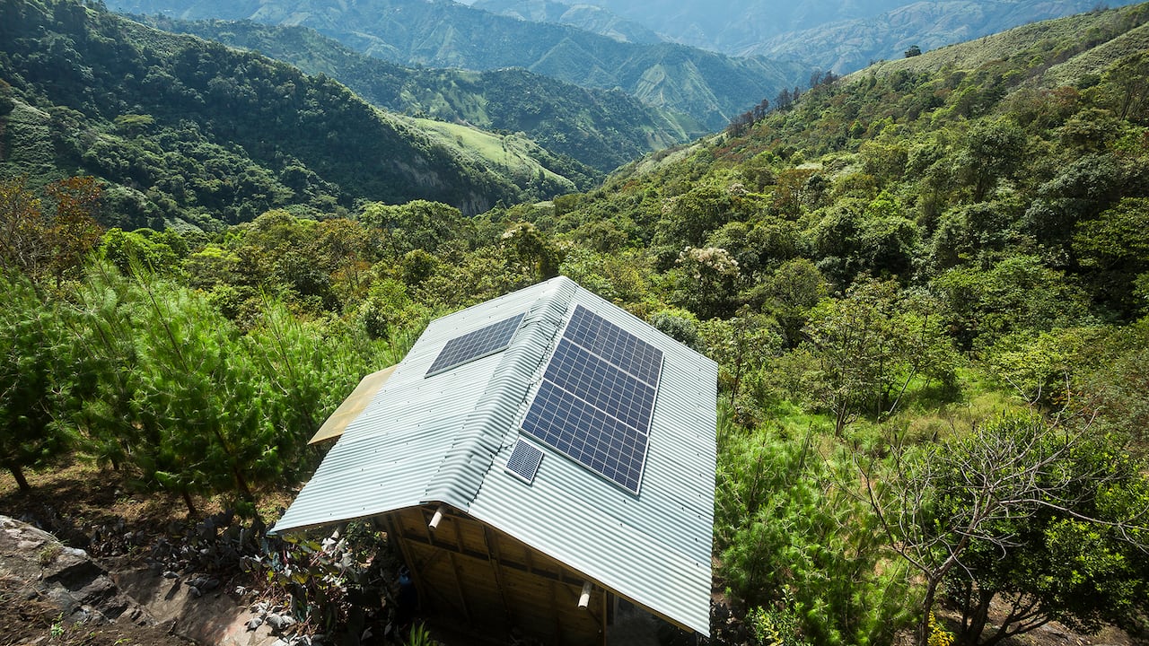 Casa de madera tradicional con paneles solares en las montañas de Colombia