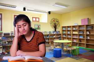 Bookshelves with literature, round table, and chairs for relaxed reading.