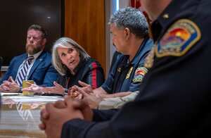 Gov. Michelle Lujan Grisham, second from left, with Deputy Cabinet Secretary of the Department of Public Safety Benjamin Baker, left, Albuquerque Police Chief Harold Medina, right, speaks during a news conference, Friday, Sept. 8, 2023 in Santa Fe, N.M. Grisham is asking the U.S. Justice Department to deploy more federal agents to the state in the aftermath of the shooting death of an 11-year-old boy outside a minor league baseball stadium. (Jon Austria/The Albuquerque Journal via AP)