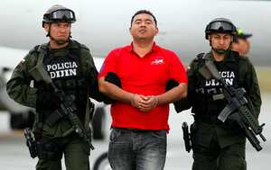 Jorge Luis Alfonso Lopez, center, is escorted by police on a airport tarmac after arriving in Bogota, Colombia, Thursday, Aug. 2, 2012. Alfonso Lopez is a former mayor of Magangue and the son of a controversial businesswoman known as "La Gata', now under house arrest for her ties to paramilitary groups. Alfonso Lopez, who is facing murder charges for two men; one a journalist, the other a student, was captured on a farm near Colombia's Caribbean coast, Thursday morning. (AP Photo/Fernando Vergara)
