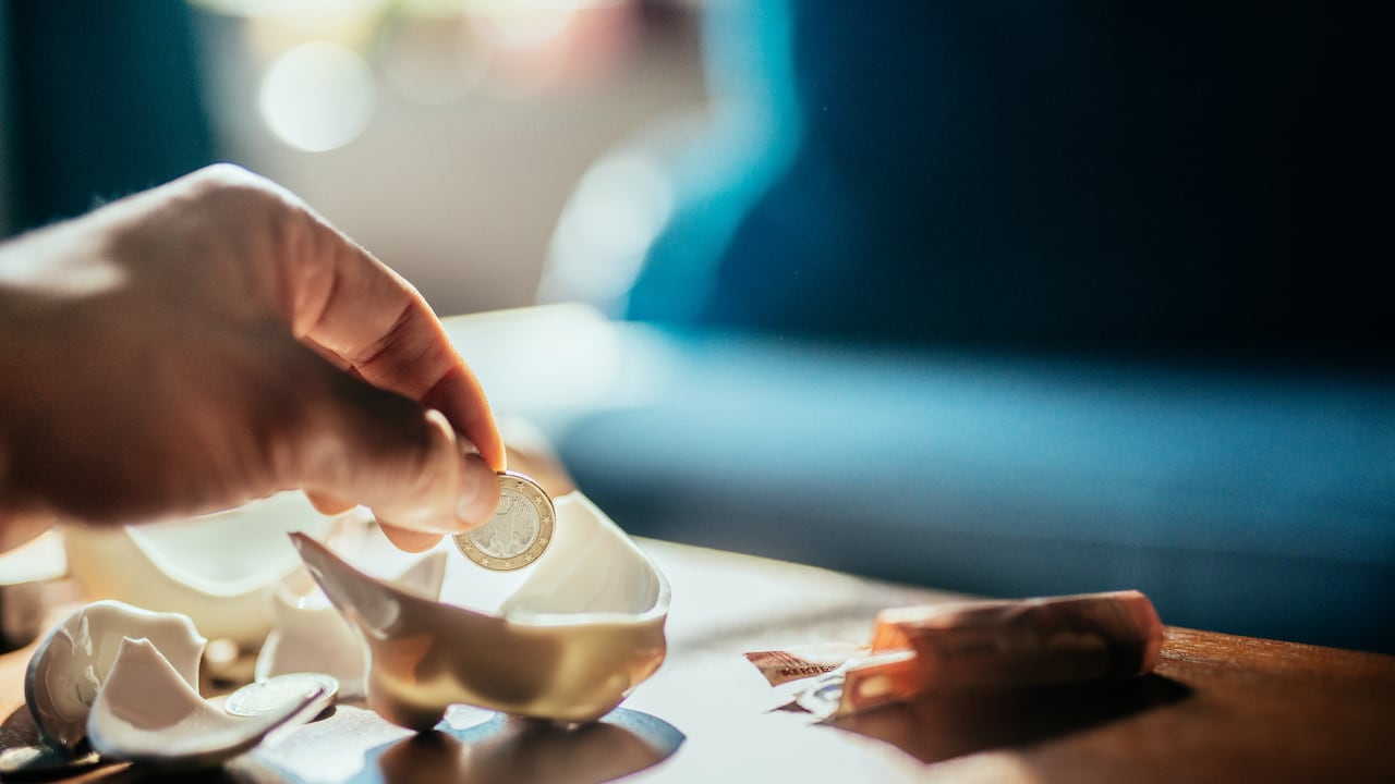 Counting saving coins from broken piggy bank.