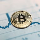 London, UK - 04 22 2021: Bitcoin coins cryptocurrency on financial data chart background.