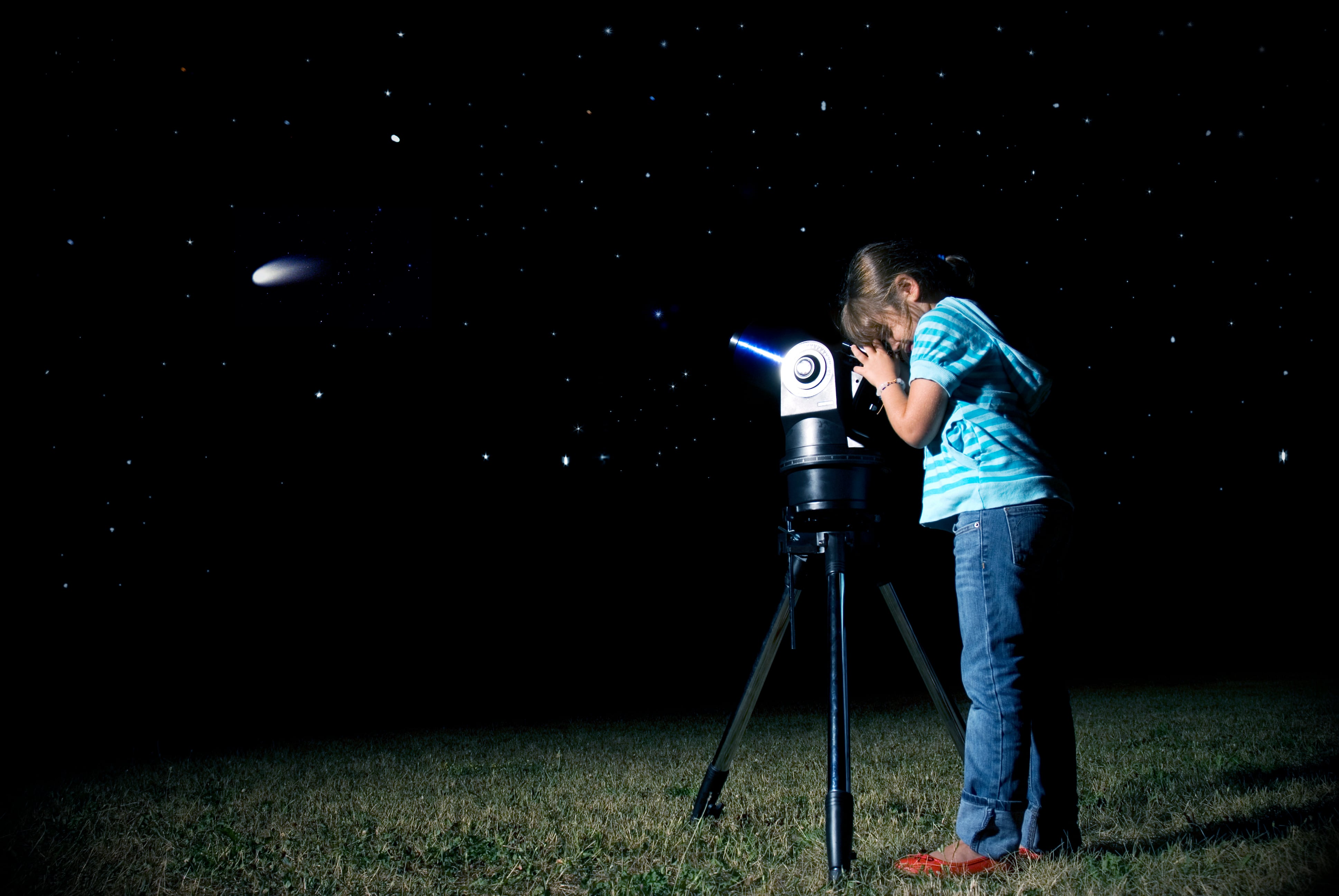 "Young girl, out in a field, looking to a comet through a telescope. (Comet image coming from public domain NASA archives)See,too:"