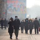 People wearing face masks to prevent the spread of the coronavirus walk at a pedestrian shopping street in Beijing, Saturday, Jan. 23, 2021. (AP Photo/Mark Schiefelbein)