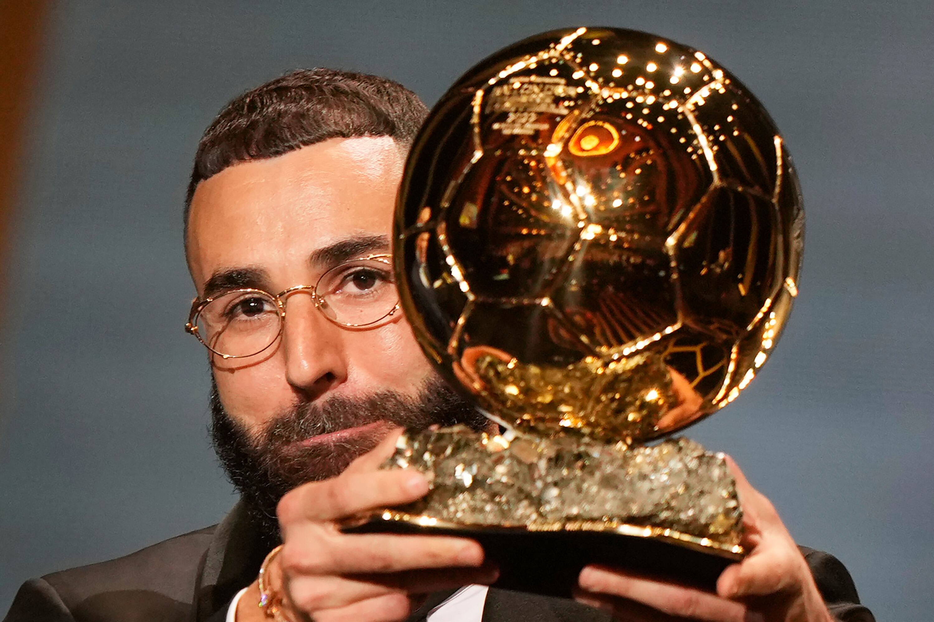 Real Madrid's Karim Benzema celebrates after winning the 2022 Ballon d'Or trophy during the 66th Ballon d'Or ceremony at Theatre du Chatelet in Paris, France, Monday, Oct. 17, 2022. (AP Photo/Francois Mori)
