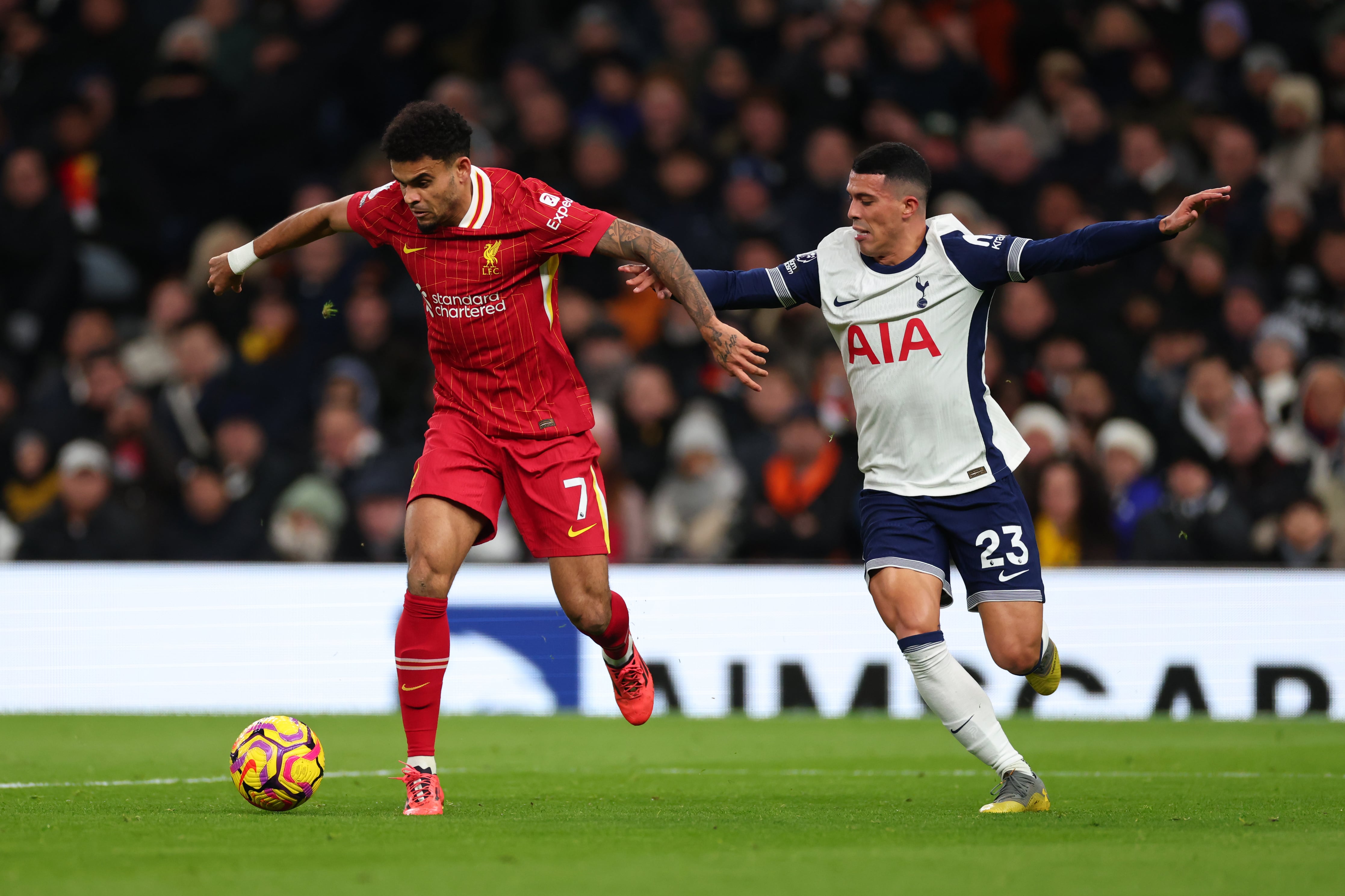 LONDON, ENGLAND - DECEMBER 22: Luis Diaz of Liverpool in action with Pedro Porro of Tottenham Hotspur during the Premier League match between Tottenham Hotspur FC and Liverpool FC at Tottenham Hotspur Stadium on December 22, 2024 in London, England. (Photo by Marc Atkins/Getty Images)