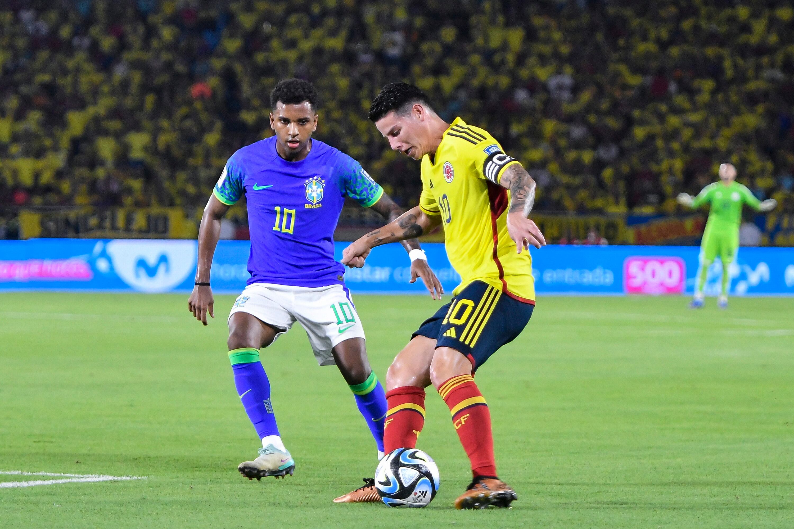 BARRANQUILLA, COLOMBIA - NOVEMBER 16: James Rodriguez of Colombia battles for possession with with Rodrygo of Brazil during the FIFA World Cup 2026 Qualifier match between Colombia and Brazil at Estadio Metropolitano Roberto Meléndez on November 16, 2023 in Barranquilla, Colombia. (Photo by Gabriel Aponte/Getty Images)