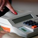 A woman prepares to cast her vote during the legislative and presidential election, in Sao Paulo, Brazil, on October 2, 2022. - Voting began early Sunday in South America's biggest economy, plagued by gaping inequalities and violence, where voters ar expected to choose between far-right incumbent Jair Bolsonaro and leftist front-runner Luiz Inacio Lula da Silva, any of which must garner 50 percent of valid votes, plus one, to win in the first round. (Photo by Miguel Schincariol / AFP)