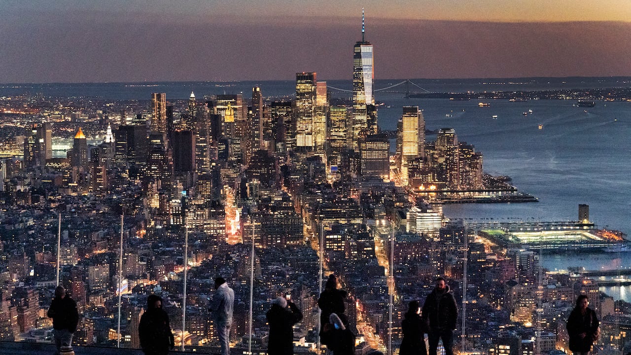 FILE - Visitors to the Edge, an outdoor observation deck 1100 feet above the ground, look at the lights of Manhattan, March 2, 2021, in New York. New York will lose one seat in Congress as a result of national population shifts, according to census data released Monday. (AP Photo/Mark Lennihan, File)