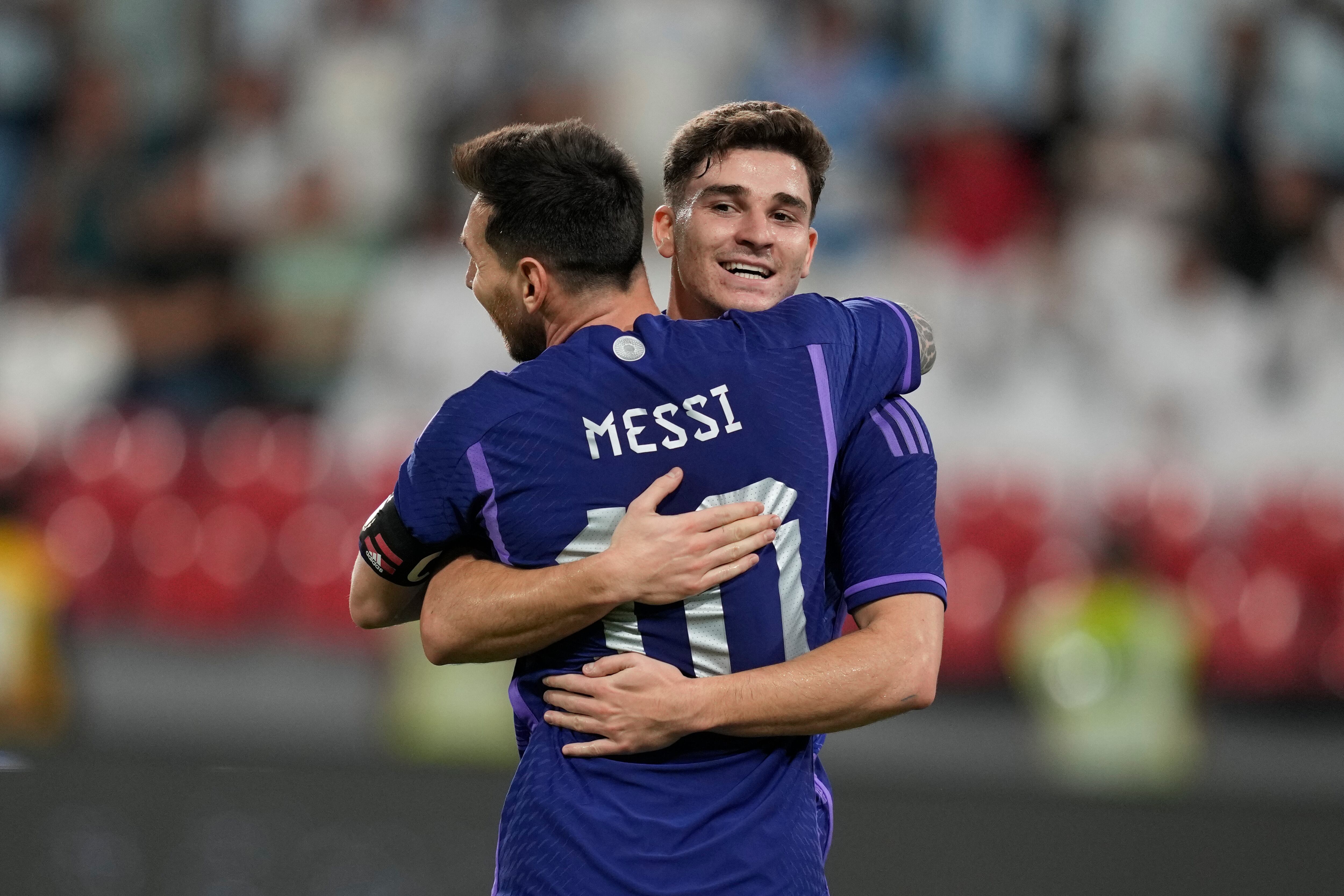 Argentina's Julian Alvarez and Lionel Messi celebrate after he scored during a friendly soccer match between Argentina and United Arab Emirates in Abu Dhabi, Wednesday, Nov. 16, 2022. (AP Photo/Kamran Jebreili)