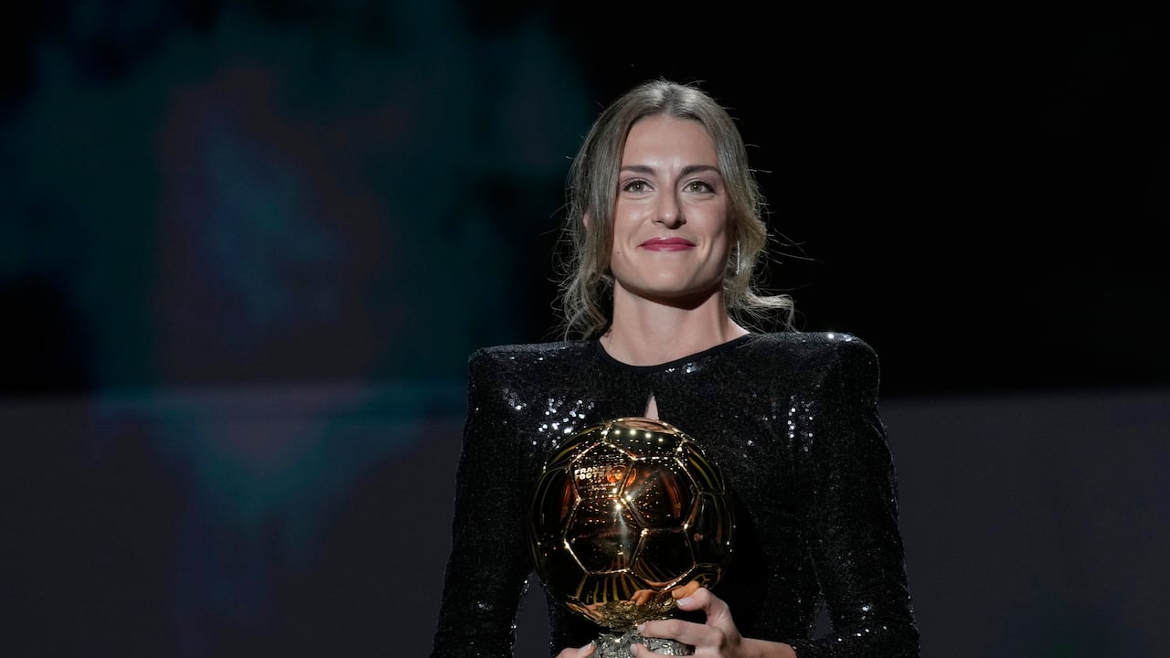 Barcelona player Alexia Putellas holds the the Women's Ballon d'Or trophy during the 65th Ballon d'Or ceremony at Theatre du Chatelet, in Paris, Monday, Nov. 29, 2021. (AP Photo/Christophe Ena)