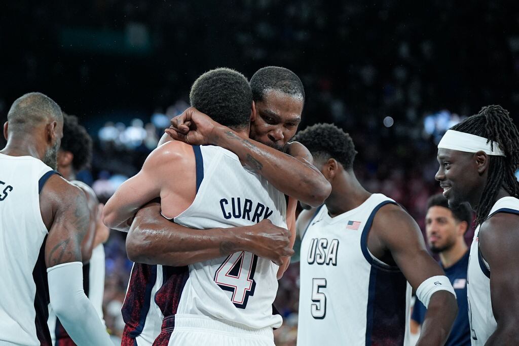 PARIS, FRANCE - AUGUST 8: Kevin Durant of United States (L) and Jrue Holiday of United States (R), Tyrese Haliburton of United States (C) celebrate their victory and entry into the Final during the Men's Semifinal Game between United States and Serbia on day thirteen of the Olympic Games Paris 2024 at Arena Bercy on August 8, 2024 in Paris, France. (Photo by Daniela Porcelli/Eurasia Sport Images/Getty Images)