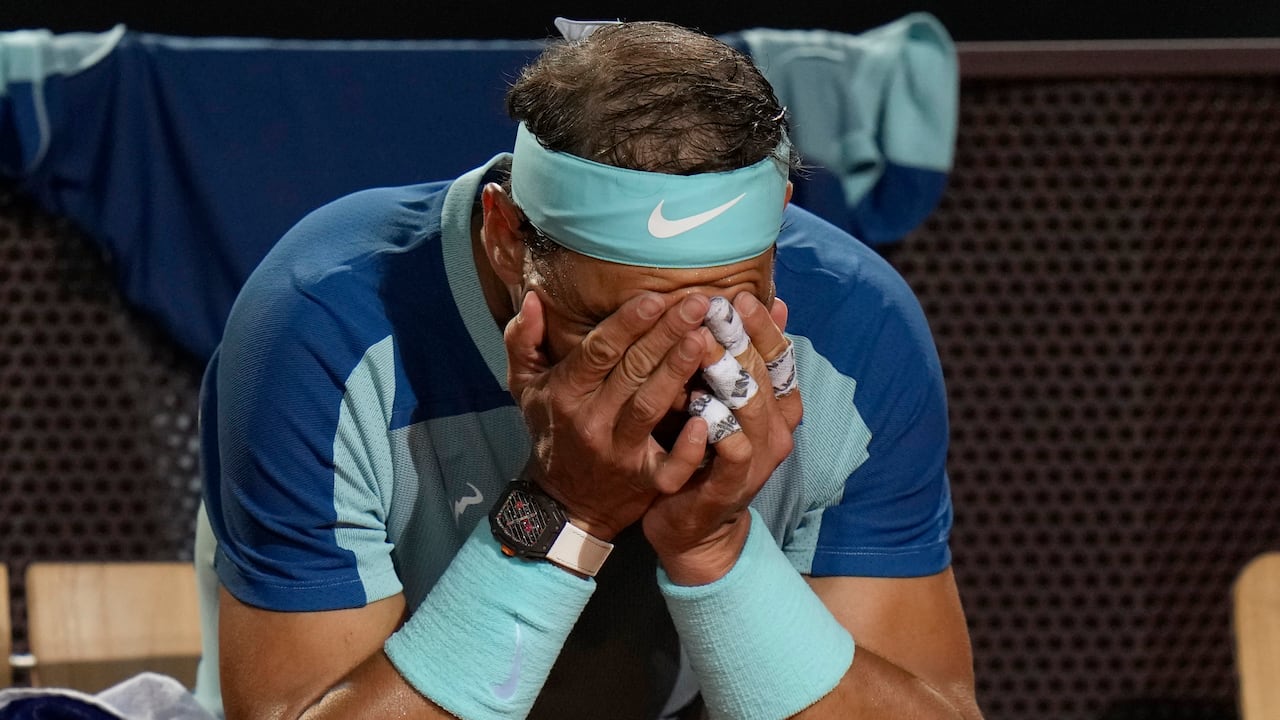 Rafael Nadal of Spain touches his face during his match against Denis Shapovalov of Canada at the Italian Open tennis tournament, in Rome, Thursday, May 12, 2022. Shapovalov beat Nadal 1-6, 7-5, 6-2. (AP Photo/Alessandra Tarantino)