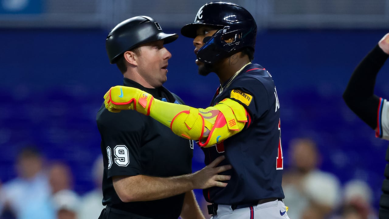 MIAMI, FLORIDA - AUGUST 27: Ronald Acuña Jr. #13 of the Atlanta Braves is held back by umpire Paul Nauert #39 after getting hit by a pitch in the third inning against the Miami Marlins at loanDepot park on August 27, 2025 in Miami, Florida. (Photo by Kelly Gavin/Getty Images)
