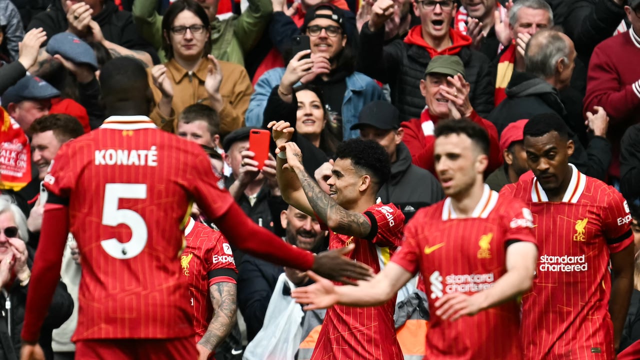 Liverpool's Colombian midfielder #07 Luis Diaz (C) celebrates with teammates after scoring his team first goal during the English Premier League football match between Liverpool and West Ham United at Anfield in Liverpool, north west England on April 13, 2025. (Photo by Paul ELLIS / AFP) / RESTRICTED TO EDITORIAL USE. NO USE WITH UNAUTHORIZED AUDIO, VIDEO, DATA, FIXTURE LISTS, CLUB/LEAGUE LOGOS OR 'LIVE' SERVICES. ONLINE IN-MATCH USE LIMITED TO 120 IMAGES. AN ADDITIONAL 40 IMAGES MAY BE USED IN EXTRA TIME. NO VIDEO EMULATION. SOCIAL MEDIA IN-MATCH USE LIMITED TO 120 IMAGES. AN ADDITIONAL 40 IMAGES MAY BE USED IN EXTRA TIME. NO USE IN BETTING PUBLICATIONS, GAMES OR SINGLE CLUB/LEAGUE/PLAYER PUBLICATIONS. /