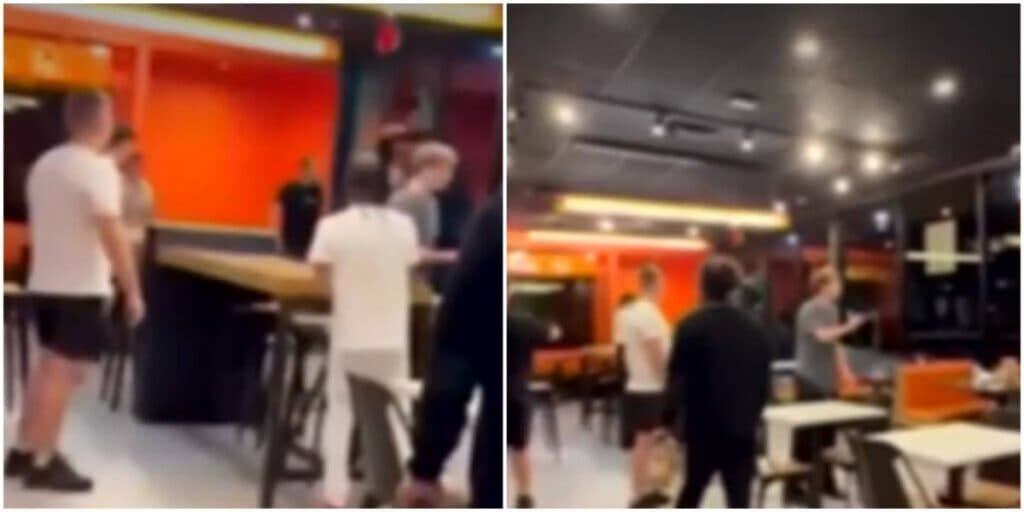 Hombres discutiendo y levantando sillas en medio de una pelea dentro de un restaurante Burger King en Brickell, Miami.